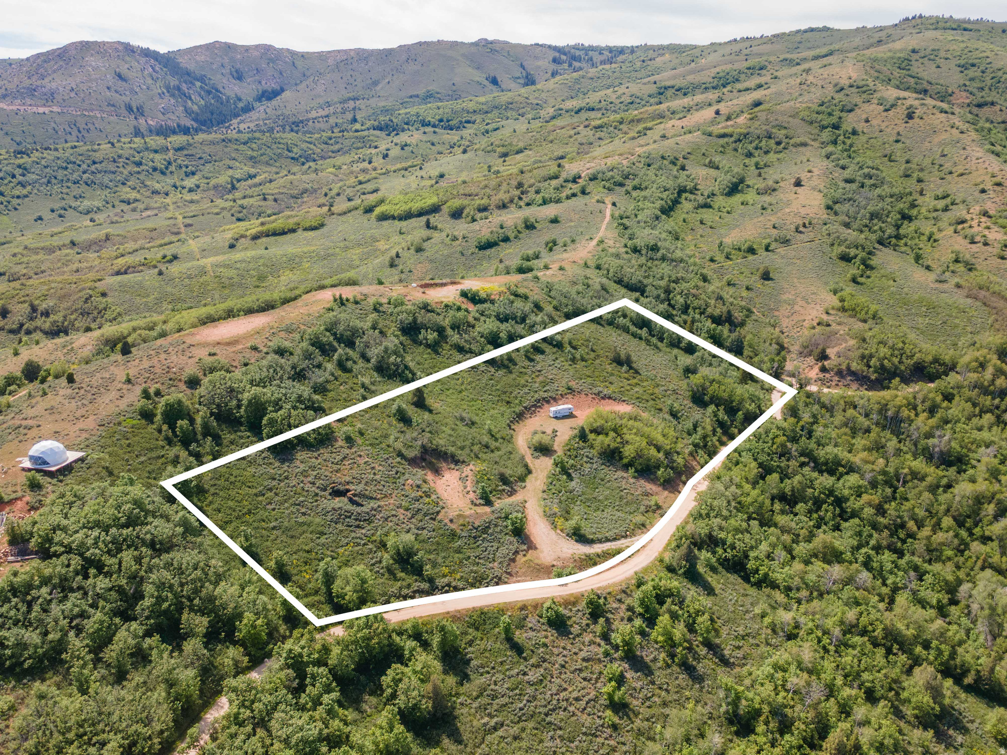 Amazing recreational/residential opportunity in Evergreen! This sale includes TWO separate parcels: 2719 N High Pine Ave (Tax ID: 230270003) and 2775 N High Pine Ave (Tax ID: 230270004), offering additional space, privacy, and flexibility in a quiet mountain setting. Located on a well-maintained dirt road with great access directly off Evergreen Park Drive, these elevated lots offer incredible views and a peaceful secluded atmosphere surrounded by nature. While the roads are not plowed in the winter, the property remained accessible throughout last winter. A trailer is included in the sale, making this an excellent opportunity for a summer  getaway, camping retreat, or future mountain escape. Conveniently located near Causey Reservoir and endless outdoor recreation, this is the perfect spot to enjoy the beauty and quiet of Northern Utah's mountains.  Sign on lots.  Contact agent for directions.    To build a residence you would need a well & septic tank.   450 sq ft minimum build.  Go in on this with someone you like and share the driveway and a fire & smores.  Firepit included.