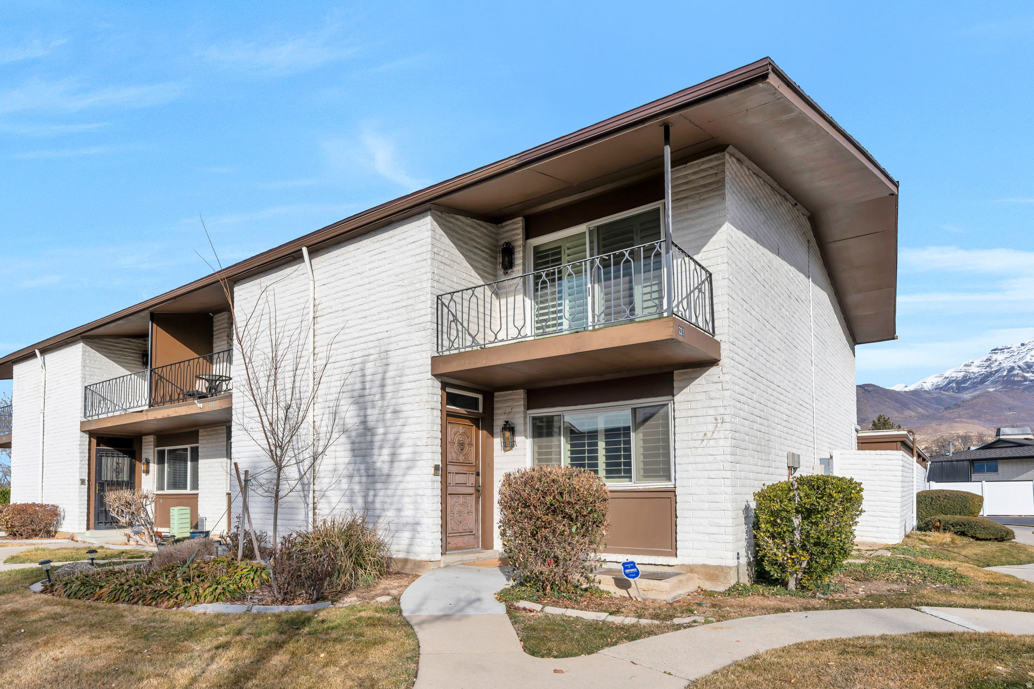 Updated end-row townhome in the desirable Three Fountains community in Provo. The main level features a bright kitchen with white cabinetry, butcher block countertops, and a built-in dishwasher, flowing into a spacious living area with natural light, plantation shutters, and durable LVP flooring throughout the first floor. Upstairs, both bedrooms include ensuite bathrooms, with the primary suite offering a walk-in closet and private balcony. The finished basement adds valuable living space with an additional family room, bedroom, bathroom, and abundant storage. Enjoy a private patio for outdoor relaxation and a covered carport with two parking spaces. Community amenities include a pool, clubhouse, and park. Conveniently located near Hillcrest Elementary, Riverwoods shopping and dining, BYU, and quick access to so much more! Measurements provided as a courtesy only, buyer to verify all info.