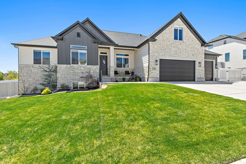 **Price drop** If you are searching for a beautiful newer home in Highland with stunning views and convenient single-level living, this is the one. The home features a gorgeous white oak kitchen complete with double ovens and a spacious island that seamlessly connects to the open dining area and great room, highlighted by vaulted ceilings. Expansive windows flood the home with natural light while showcasing the serene surroundings. Backing to a protected ravine where no future building can occur, the property offers exceptional privacy and natural beauty. The main floor includes three bedrooms, two and a half bathrooms and a den just off the foyer-perfect for a home office or flex space. Upstairs, you will find an ideal hangout area with an open loft, a large bedroom and a full bathroom, along with a charming hidden closet/play area connecting the spaces. The finished basement expands your living options with two additional bedrooms, a full bathroom, a wet bar, and a massive family room-perfect for entertaining. A walk-out basement with sliding doors brings in even more natural light and provides easy access to the backyard. Outdoor living is just as impressive, featuring a deck off the main level with sliding doors and a natural gas hookup for your grill. The thoughtfully designed terraced yard includes a Bullfrog hot tub and an extra-large gas fire pit under a custom-built pergola-ideal for relaxing or hosting gatherings. Completing the home is a spacious 3-car garage with an extra-deep tandem third bay, offering plenty of room for vehicles, storage, and recreational toys. Owner/agent Square footage figures are provided as a courtesy estimate only and were obtained from builder floorplans.  Buyer is advised to obtain an independent measurement.