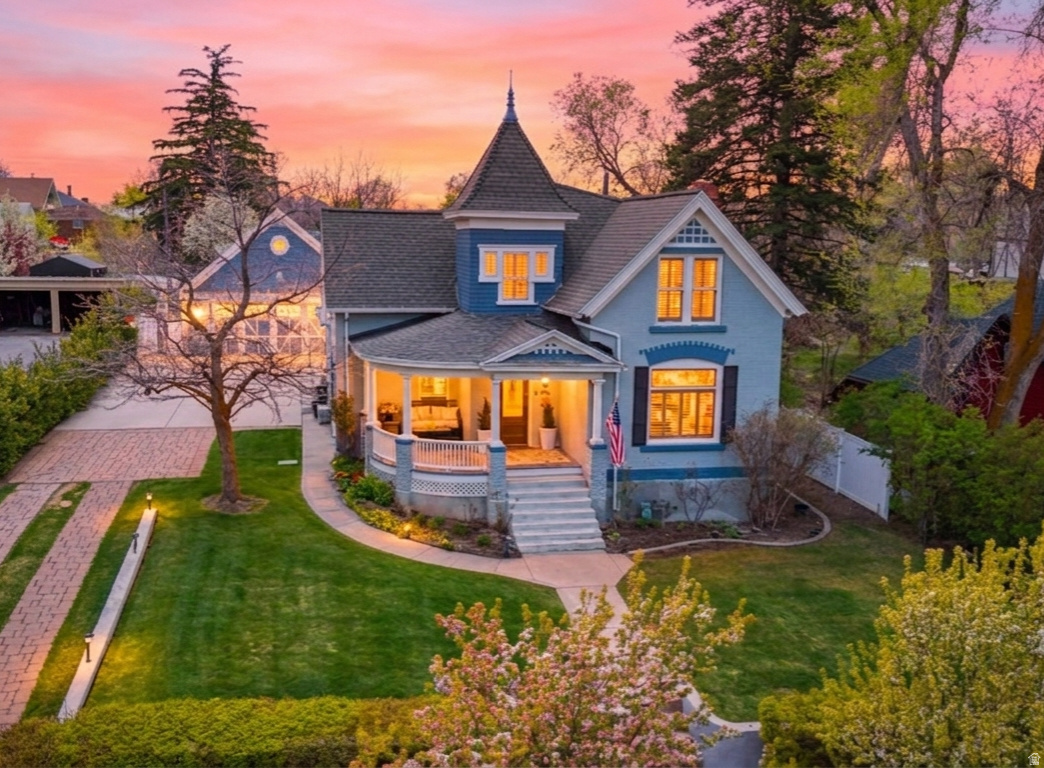 Step into the perfect blend of historic charm and modern convenience in this beautifully updated Victorian home. Thoughtfully restored to preserve its turn-of-the-century character, the home showcases timeless architectural details while offering extensive upgrades throughout.  Recent improvements include an updated kitchen, newer roof, updated windows, flooring, electrical systems, and new split heating and cooling units that provide efficient, customizable comfort year-round.  Exquisite valley and mountain views surround this incredible property, creating a breathtaking backdrop from nearly every vantage point. Enjoy stunning eastern mountain views as well as unforgettable sunsets over the Wellsville Mountains.  Situated on more than half an acre, the backyard is truly an outdoor oasis. Designed for relaxation and entertaining, the expansive yard features a swimming pool with a slide, a tranquil fish pond and waterfall feature, and a quaint garden house that adds charm and functionality to the landscape. An included -acre water share helps keep the grounds lush, green, and beautiful throughout the season.  The oversized, extra-deep garage offers plenty of room for vehicles, toys, and projects, with additional storage space above.  This rare property offers the best of both worlds-classic Victorian elegance paired with modern updates, all set on a spacious lot with unmatched outdoor amenities, spectacular views, and room to create lasting memories.
