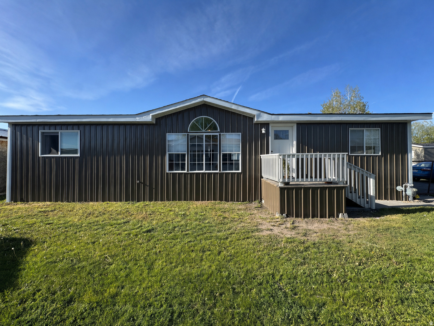 Home Sweet Home! Modern Comfort Meets Quiet Living. Welcome to a beautifully remodeled double-wide mobile home that feels brand new from the inside out, offering a perfect blend of modern upgrades and cozy charm in a safe, peaceful neighborhood. The exterior features a new roof and siding, a matching wrapped front porch ideal for relaxing or entertaining, and brand new back steps providing easy access to the yard and shed. Inside, you'll find a bright, open floor plan with durable new vinyl flooring in the main living areas and kitchen, plush new carpet in the bedrooms, and a stunning kitchen complete with new cabinetry, sleek countertops, a deep stainless steel farm sink, and new appliances including a 4-burner gas range with griddle, oven, dishwasher, plus included washer and dryer. The bedrooms are filled with natural light and offer generous closet space, while the updated bathrooms showcase modern fixtures and finishes for a spa-like feel. This move-in-ready home combines the quality of a new build with the warmth of an established community. Schedule your showing!  Square footage figures are provided as a courtesy estimate only. Buyer is advised to obtain an independent measurement. All acreage is owned by the park.