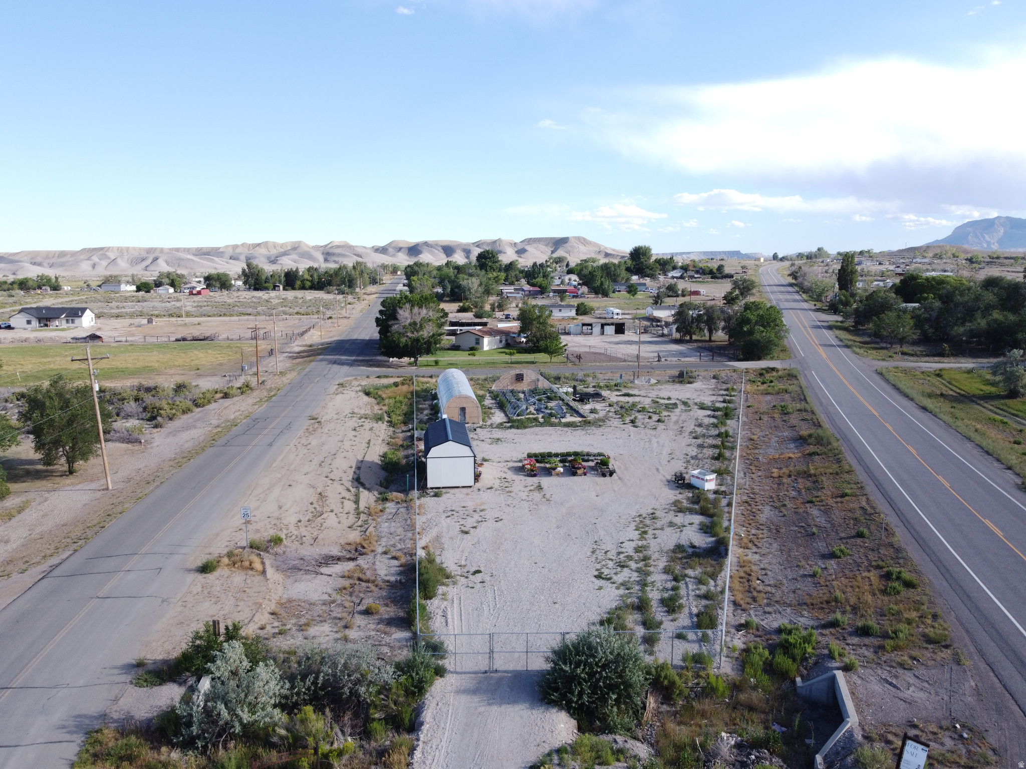Endless possibilities await on this improved 0.81-acre mixed residential/commercial property! This fully fenced property is packed with valuable improvements, saving you time and money. Power has been brought onto the property, with additional power run to multiple locations, including the included tiny house/shed. Water and sewer are already connected to the tiny house/shed, making it ideal for a workspace, office, storage, or future projects (buyer to verify permitted uses). Multiple culinary water spigots are installed throughout the property, and power has also been extended to the greenhouse areas. Whether you're looking to build, start a business, create a homestead, expand a hobby farm, or invest for the future, this property offers incredible flexibility.