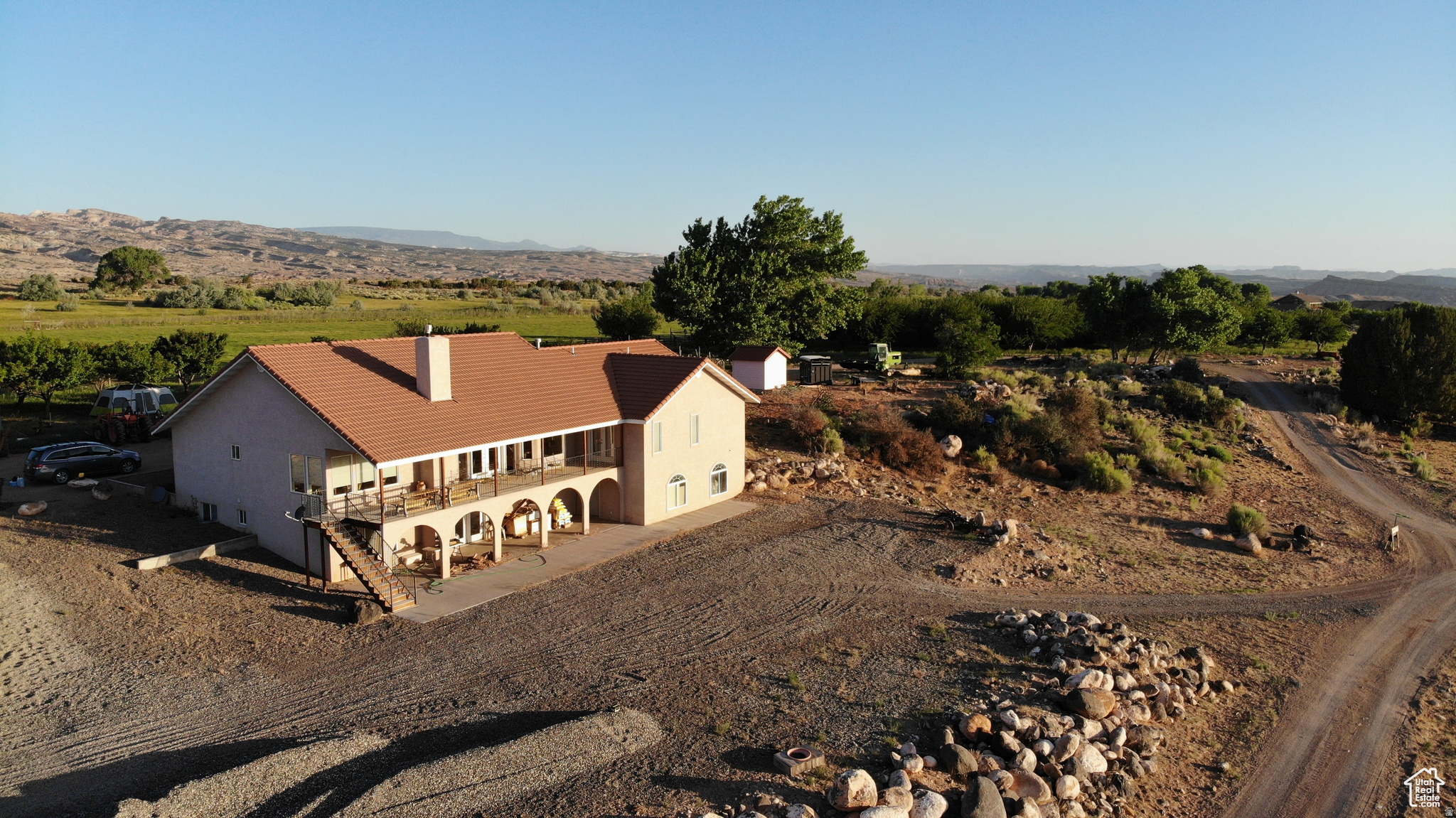 This 131 acre homesteading ranch surrounded by red rock offers a peaceful retreat and plenty of potential bordering Capitol Reef National Park. It is home to 660 apple trees, 50 apricot trees, and 25 almond trees, with ample pasture for cattle grazing and crop cultivation. There is also a 30x40' shop on the property with a concrete floor, 220 power, and a mandoor. Wildlife abounds on the ranch, including deer, mountain lions, coyotes, and turkeys. You can also enjoy the breathtaking starry nights and explore the vast ATV, horseback riding, and hiking trails. The property is centrally located and close to several popular destinations, such as Burr Trail, Boulder, Lake Powell, Torrey, Escalante, Bryce, and the Henry Mountains. Notom, where the property is located, is known as an oasis in the desert due to the availability of water. Pleasant Creek is the primary water source, and the ranch has a water right of 6.3 cfs from April to November. The water flows through a ditch that was built over a century ago by George Durfey using horses and scrapers. The ditch has since been improved with sluish gates and pipelines, but the original ditch remains. As you gaze at the lush fields of alfalfa, green pastures, and fruit trees, you realize that water is truly the lifeblood of this arid land. Additionally, farm equipment, including a Swather, bailer, 2 tractors, sprayers, marker mower, blade, gopher getter, harrow, and disc, will be included in the sale.