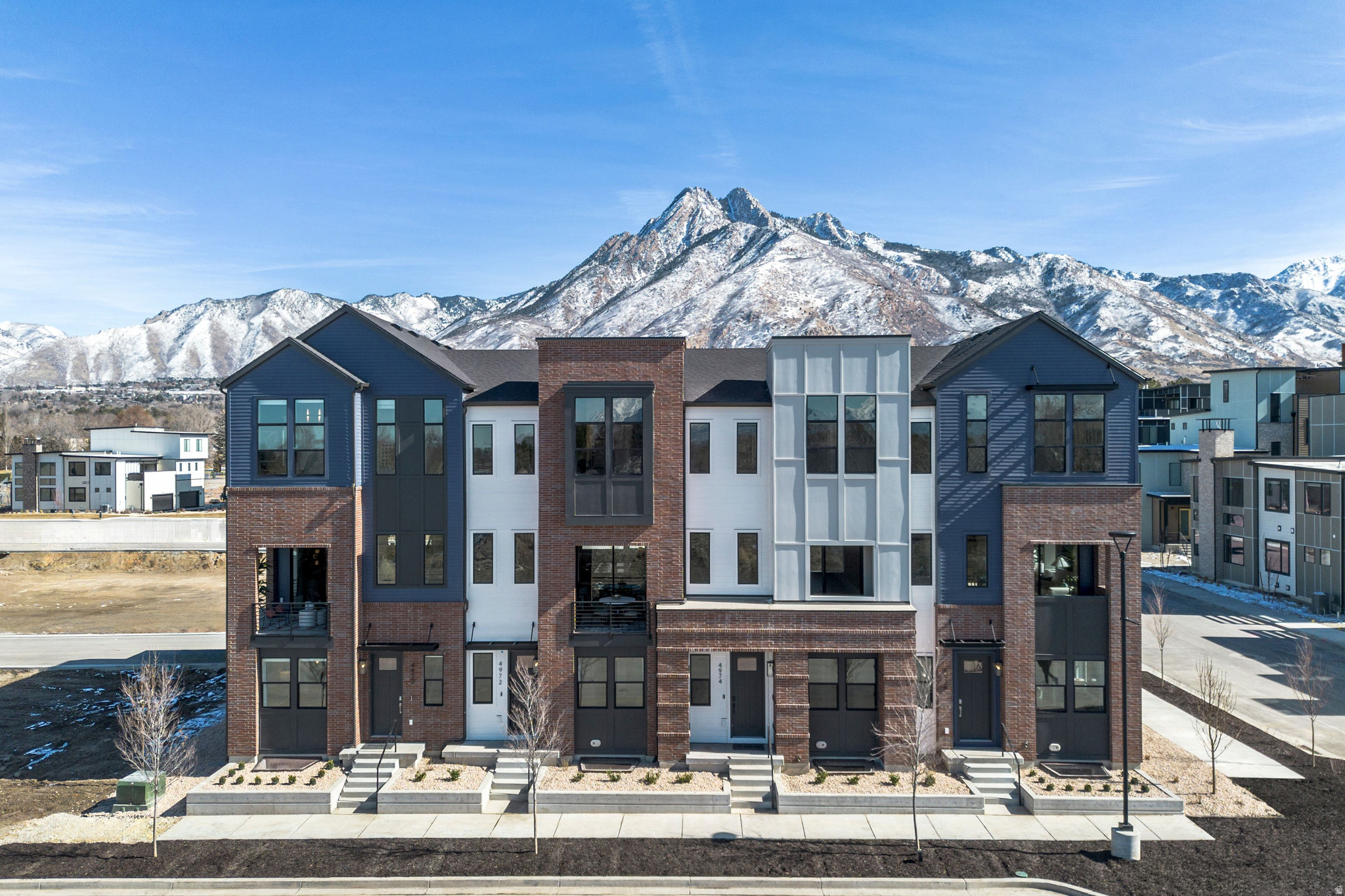 Space, sophistication, and flexibility converge in this beautifully designed brownstone in Aspire at Holladay Hills. Thoughtfully curated with soaring ceilings and open gathering spaces, this home is designed to elevate everyday living. The entry level includes a private en-suite bedroom perfect for guests or a light-drenched private office. The main level features an expansive open layout anchored by a gourmet kitchen, generous island, and seamless flow into the dining and great room areas - all enhanced by 10-foot ceilings and abundant natural light. Upstairs, three spacious bedrooms include a luxurious primary suite with 11.5-foot ceilings and dual vanities. Wide stairways, covered outdoor living, and elegant architectural details define the home's refined character. Situated within Aspire at Holladay Hills by Tri Pointe Homes, part of the visionary Holladay Hills redevelopment in Holladay, residents enjoy a truly walkable lifestyle with curated retail, dining, and office spaces. Located at the foothills of the Wasatch Mountains with stunning Mount Olympus views, this community offers convenient access to Salt Lake International Airport (20 minutes) and world-renowned ski resorts (25 minutes). Square footage figures are provided as a courtesy estimate only and were obtained from the builder. Buyer is advised to obtain an independent measurement.