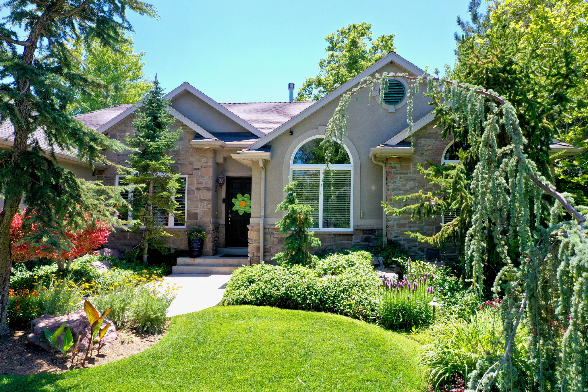 Discover elevated living in this exceptional Draper rambler, perfectly situated on a premier corner lot with breathtaking mountain views. This beautifully appointed home offers 5 spacious bedrooms, 3.5 baths, rich hardwood floors, a private theater, and an entertainer's wet bar. Step outside to your own backyard retreat featuring an outdoor kitchen, hot tub, putting green, mature landscaping, RV parking, and a 3-car garage. Thoughtfully designed for both everyday comfort and unforgettable entertaining, this home is a rare blend of luxury, space, and timeless appeal.