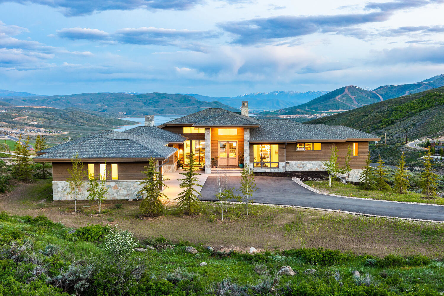 Modern Mountain Luxury in Deer Vista with Jordanelle Reservoir & Deer Valley Views. Some homes have views. Some have design. A rare few have both, plus the kind of privacy that makes you actually exhale. This is one of those homes. Nearly 5,800 square feet of modern mountain architecture sits on one of Deer Vista's most coveted parcels, oriented to capture direct sightlines to Jordanelle Reservoir and Deer Valley's East Village from the moment you walk through the door. The layout is thoughtful in the way that only comes from genuine intention. The main level opens dramatically, flows naturally, and earns every square foot. The primary suite is on the main floor, a detail that matters more than people realize until they're living it. Private balcony, steam shower, soaking tub, and a dedicated fitness room just steps away. The living area anchors around a striking fireplace and nesting doors that disappear entirely, dissolving the line between the interior and the deck beyond. The kitchen is serious: Sub-Zero, Wolf, a butler's pantry that keeps the entertaining seamless and the counters clear. A heated three-car garage, mudroom, and generous storage handle the mountain lifestyle without apology. Downstairs, four additional bedrooms and a family room with wet bar give everyone room to spread out. The sunken 10-person saltwater spa is the kind of feature that sounds like a luxury until it's 9pm after a ski day, then it's a necessity. Downtown Park City and Deer Valley's East Village are both within easy reach. This home works as a primary residence. It works as a mountain escape. It works, frankly, exceptionally well. Reach out to arrange a private showing.