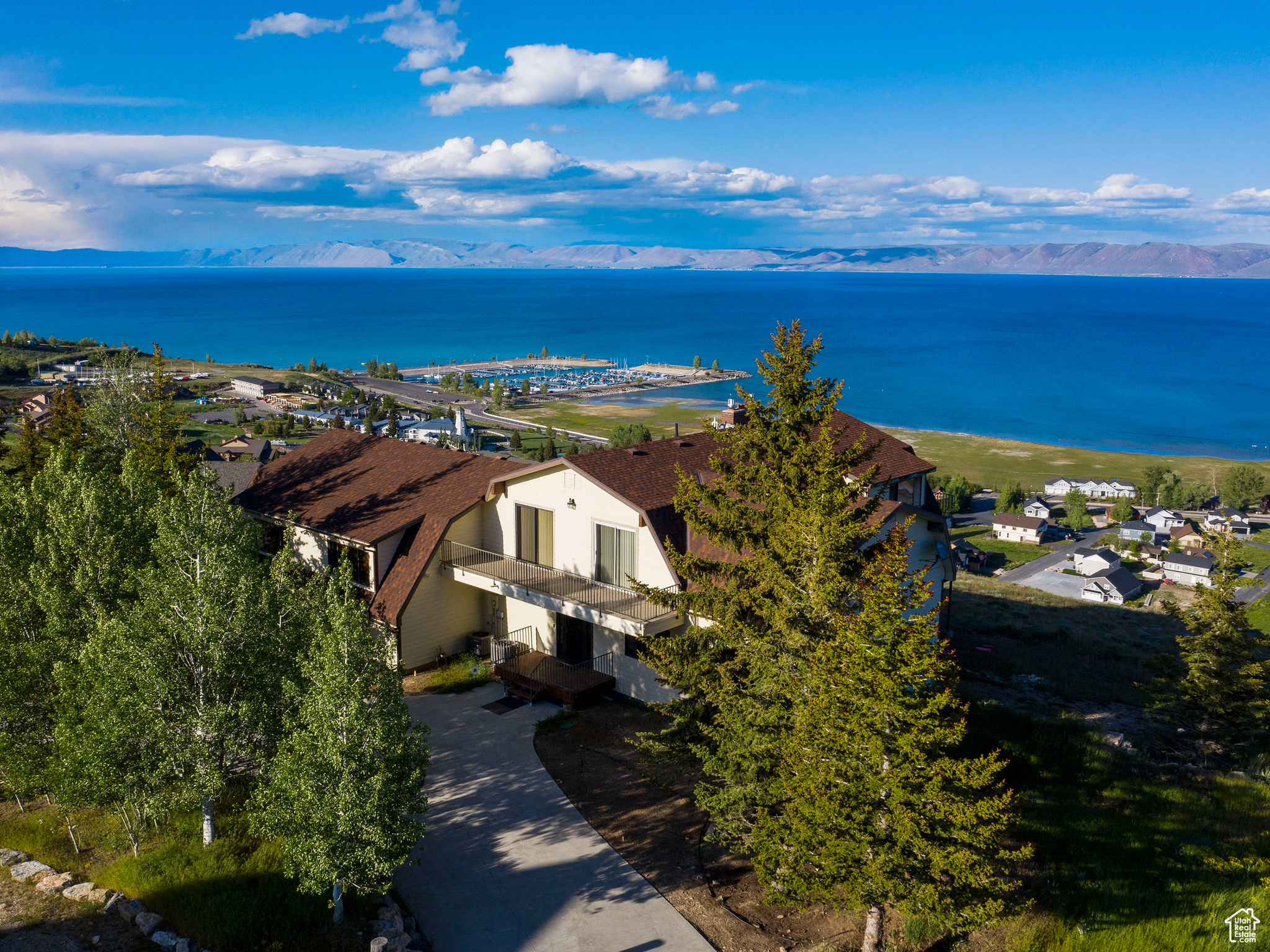 TURNKEY REMODEL BEAR LAKE RETREAT WITH TOYS INCLUDED! NOW OFFERED AT $1,690,000 This expansive 7-bedroom, 6-bath residence, spanning 7,000 square feet in Bear Lake, seamlessly blends luxury, comfort, and exceptional income-generating potential.  Enjoy family fun from day one with a waterski boat and 6-seater all-terrain vehicle included in the sale. Sleeps up to 50 guests and showcases breathtaking panoramic views.   **Brand new remodel in progress, scheduled for completion in June 2026, featuring new carpet, new flooring, fresh paint, new cabinets, and new countertops-bringing a modern, updated feel to this already impressive retreat.**  The property is distributed across three levels and features two complete kitchens, making it optimally configured for multiple families or large group accommodations. Start having family fun on day one with this cabin!  Included in the sale is a 2000 Glastron waterski boat (approximately 220 hours) equipped with a Volvo Penta V8 5.0L engine, ski tower, bimini top, travel cover, and matching EZ Load dual-axle trailer-perfectly suited for immediate enjoyment on Bear Lake. Also included is a 2023 Can-Am HD10 Lonestar 6-seater all-terrain vehicle with fewer than 4,000 miles, offering additional adventure and recreation right from your doorstep.  A full-size elevator provides convenient access across all three floors, ensuring effortless mobility for guests of all ages, while also simplifying luggage and grocery transport. The home is being sold fully furnished and is completely turnkey, complete with a proven rental history and the capacity to sleep up to 50 guests-ready for immediate personal enjoyment or revenue generation.  Notable amenities include a comprehensive game room, hot tub, sauna, and panoramic lake views. Recent capital improvements include a new outdoor hot tub and indoor sauna, refreshed landscaping with a designated firepit area and added deck stairs, expanded gravel and parking areas, new basement furnishings and television, updated light fixtures, and new rain gutters.  Adjacent lot to the north included in the sale.   Please note that all square footage figures are provided as a courtesy estimate only. Buyer is advised to obtain an independent measurement.