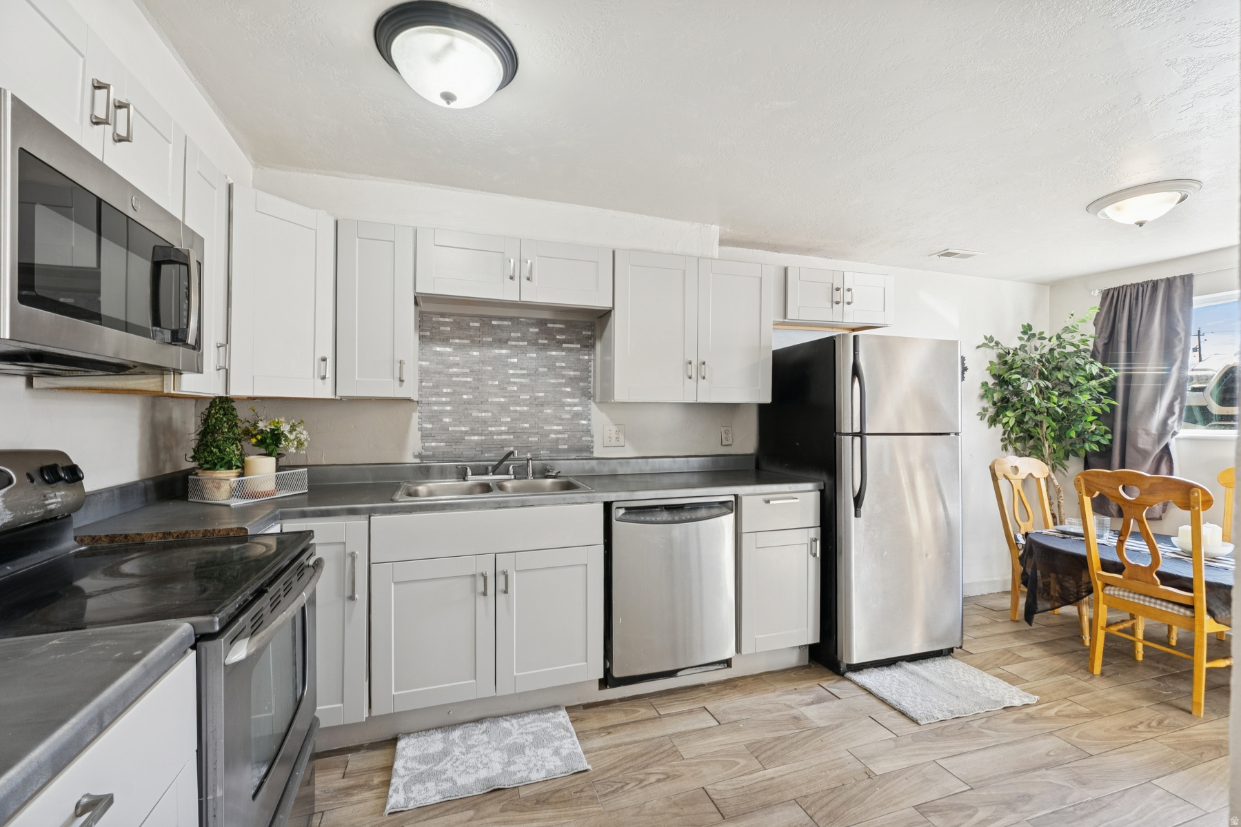 This beautifully remodeled 2-bedroom, 1-bath condo offers a functional layout with approximately 800 square feet of living space. Located near major commuter routes, shopping, and downtown amenities, it's ideal for first-time buyers, investors, or anyone seeking low-maintenance ownership. At $1,350 a month, the condo has rented for less than its potential return The unit features central air, a full kitchen with appliances included. Dedicated parking and a low monthly HOA add to the value. This community has easy access to parks and public transit, this property offers practical comfort in a central location.