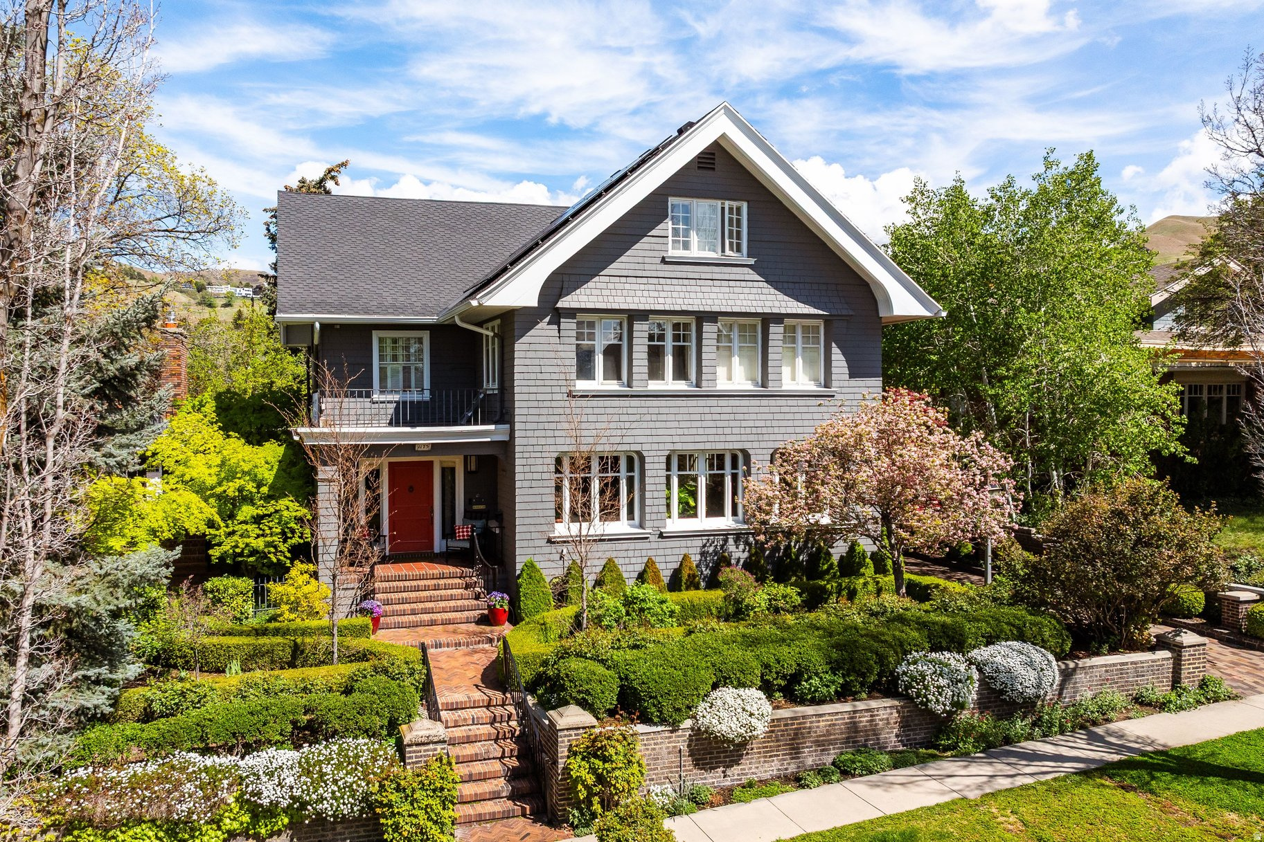 Nestled in the coveted East side of the Lower Avenues, this remarkable, 1905 mini estate blends timeless character with thoughtful modern updates - a true secret garden just outside the city. Known historically as the Steiner Mansion, this lovingly restored home is a Greene & Greene design, showcasing rich craftsmanship, architectural detail, and enduring style. Inside, you'll find beautifully preserved elements like exquisite hand-painted wallpaper, original tiling and flooring, and carefully executed custom historic retrofits that honor the home's legacy while enhancing everyday livability. Warm woodwork, and curated finishes create an inviting and distinctive interior. The property offers an exceptional indoor-outdoor flow, perfect for wonderful parties, holiday celebrations, and endless memory making. A beautiful pergola complete with electricity, gorgeous horticulture surrounding the property including edible grapes, tricolor birches, meadow planting, and a recently added custom swimming pool-completed within the last decade-brings a fresh, luxurious touch to the historic setting. A rare opportunity to own a true piece of history with all the comforts of modern living, this home is a fabulous entertaining retreat in one of the city's most desirable neighborhoods.