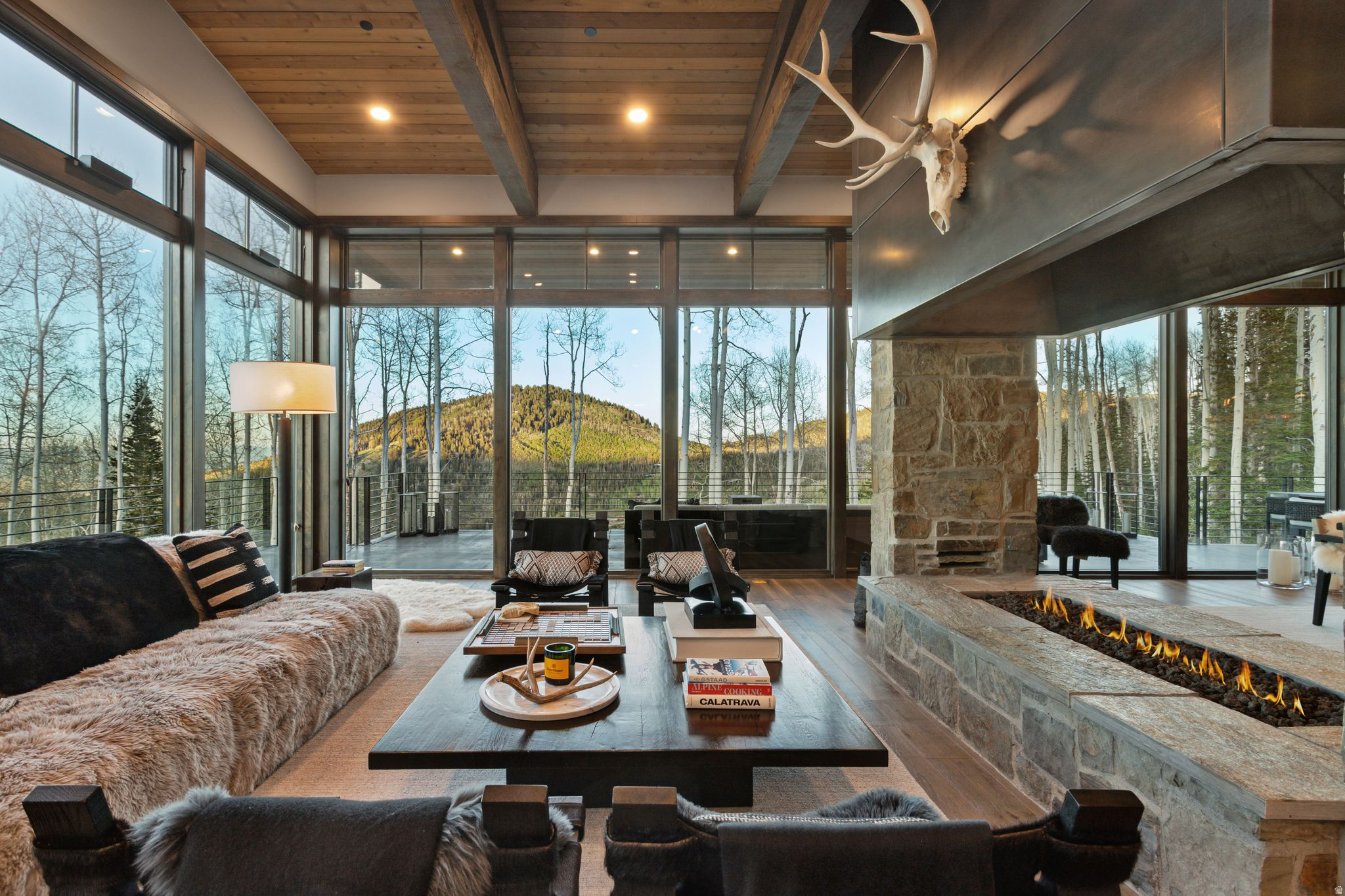 Nestled in the exclusive Colony at White Pine Canyon in Park City, Utah, this stunning modern mountain retreat offers unparalleled luxury and direct ski-in/ski-out access via the Mirage ski run, with connectivity to Dreamscape, Dreamcatcher, Tombstone, and Iron Mountain Express lifts. Thoughtfully designed by renowned architect Michael Upwall, the home blends contemporary design with natural alpine elements, using a striking mix of steel, glass, wood, and custom stonework to create a timeless architectural masterpiece. Expansive floor-to-ceiling windows frame panoramic views of the ski resort and down valley, flooding the open concept interior with natural light. The main living area flows effortlessly into a gourmet kitchen and skywalk, perfect for entertaining or relaxing aprs-ski. This home features a glass elevator, a spacious ski locker room, extra large covered hot tub, heated driveway, and smart home technology throughout. Whether hosting family or guests, the thoughtfully designed layout includes 5 bedrooms, one of which is a stylish bunk room, and eight bathrooms. For moments of recreation and rejuvenation, the residence also includes a dedicated in house gym, a game room, and a private home office with inspiring views. Every detail has been meticulously crafted to reflect the beauty of the surrounding Wasatch Mountains while delivering the modern comforts of an elite mountain lifestyle. This one-of-a-kind estate is a rare opportunity to own a legacy property in one of North America's most prestigious ski communities. Call today for your private showing.