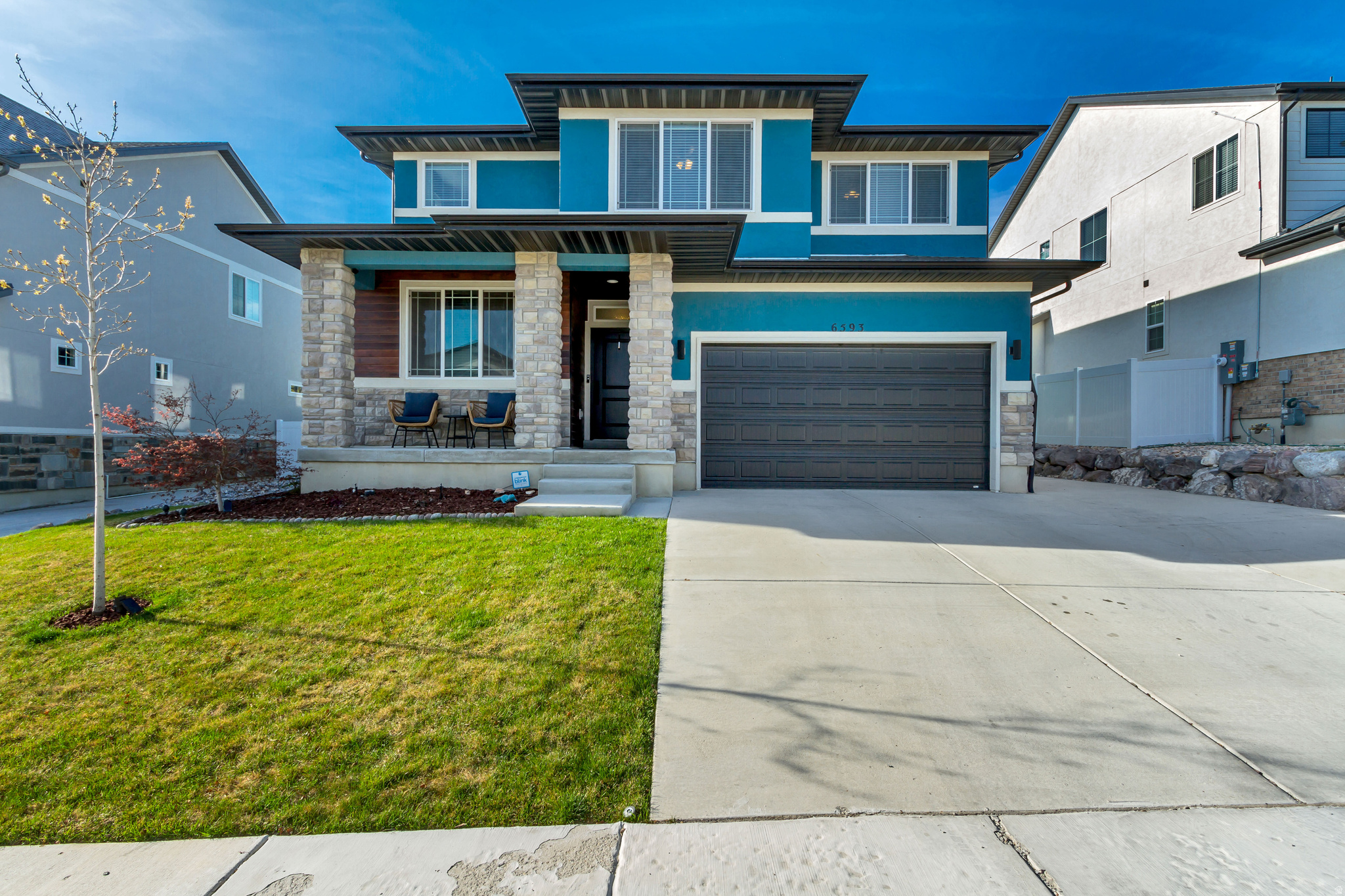 Beautiful two-story home located in the Orchard Heights community, offering easy access to nearby shopping, dining, and schools. Well-planned layout with six comfortably sized bedrooms, a private enclosed office, and a versatile den upstairs. Generous storage and well-sized closets are found throughout. The kitchen is designed as a central gathering space, complete with stainless steel appliances, double wall ovens, a built-in six-burner gas cooktop, and an oversized island. Finishes include white shaker-style cabinetry with black hardware, quartz countertops throughout, and a large adjoining dining area. Durable, water-resistant laminate flooring extends across the main level, bathrooms, and laundry room. The living room features built-in shelving and a modern fireplace, creating a warm and functional space for everyday living or entertaining. Upstairs bathrooms continue the cohesive design with shaker cabinets and quartz surfaces. The primary suite offers a spacious retreat with a walk-in closet featuring custom wood shelving, along with a private bath that includes a soaking tub, separate oversized shower, and dual vanities.  Laundry room is conveniently located upstairs between the bedrooms. Home has solar panels installed March 2023 and includes a backup battery.