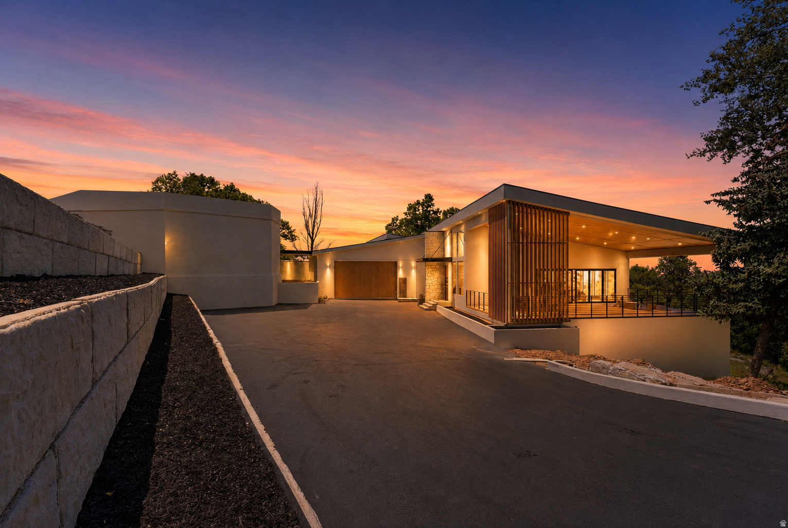 Newly Complete - 2662 Comanche Drive: a once-in-a-generation trophy estate and arguably the most anticipated residential offering in Salt Lake City.  Set on a private enclave on over an acre of mature, park-like grounds, this newly completed architectural masterpiece spans 10,539 square feet and represents the culmination of years of vision, design, and craftsmanship. The estate is anchored by the legendary 25-car gallery garage, a 1 of 1 automotive sanctuary resurrected from the former home of the owner of the Salt Lake International Cars Museum and reimagined as one of the most extraordinary collector garages in the country.  Upon arrival, a striking composition of modern architecture infused with timeless mid-century influences emerges from the landscape. Inside, soaring 18-foot vaulted ceilings clad in natural white oak create a dramatic sense of scale, while walls of glass frame the surrounding grounds and flood the home with natural light. Every surface has been meticulously curated, showcasing an exceptional blend of natural stone, handcrafted woodwork, marble, and quartzite.  Designed for both entertaining and intimate daily living, the residence offers an unparalleled collection of amenities. Highlights include an extraordinary indoor mid-century-inspired pool with walk-out shower, an executive office, custom-carved marble soaking tub, rooftop sports court with panoramic valley and aircraft views, and thoughtfully designed family spaces including dual children's suites connected by an upper loft retreat.  What makes this estate truly remarkable is its ability to feel worlds away while remaining remarkably connected. Surrounded by lush landscape and complete privacy, it is located just 15 minutes from Salt Lake City International Airport and 20 minutes from Park City, home to the renowned "Greatest Snow on Earth."  2662 Comanche Drive stands as a landmark residence a property that could never be replicated in today's market.  Landscape Plan available - to be installed Summer '26.
