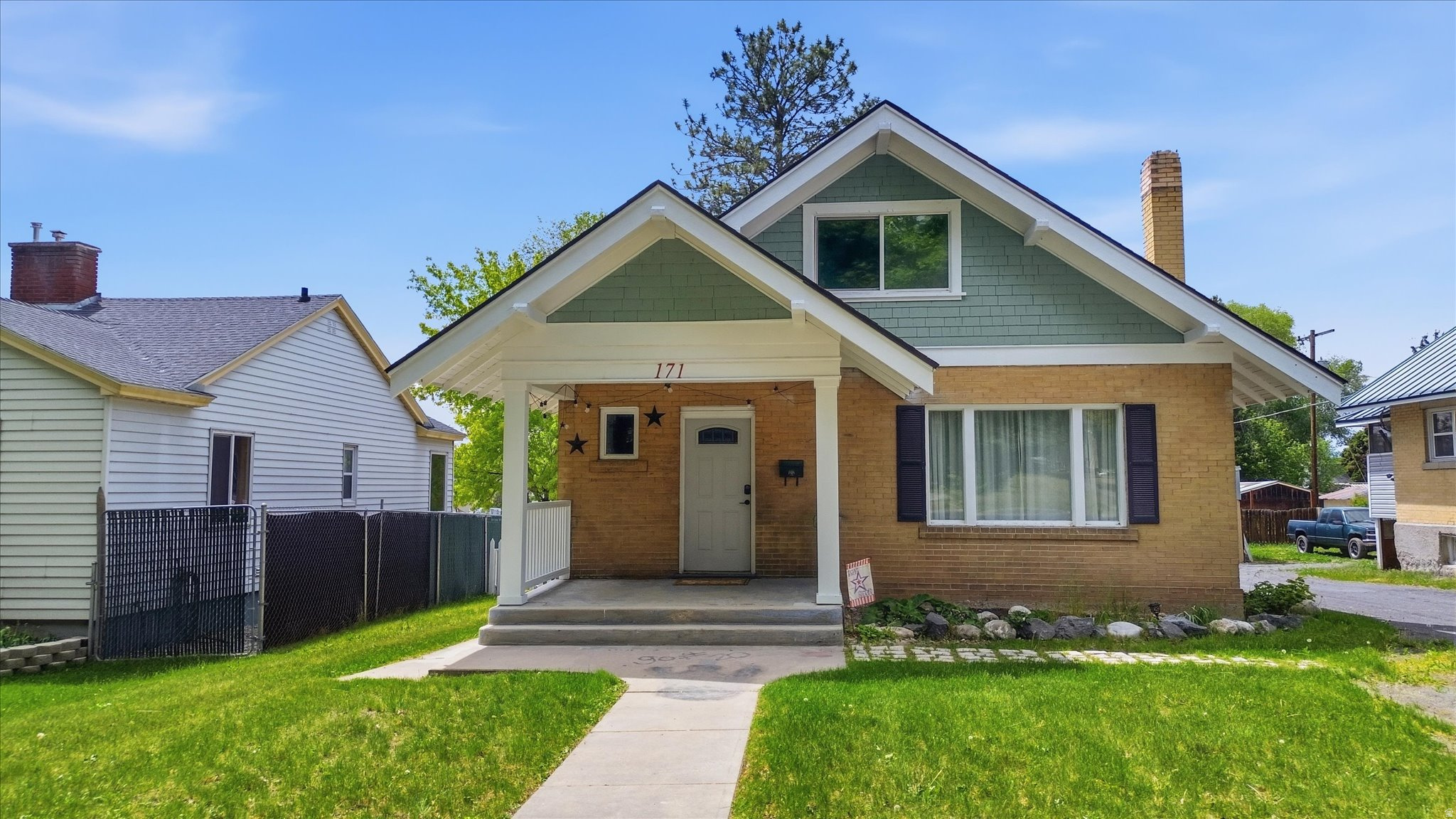PRICE ADJUSTED!!  Welcome to your new favorite house - this sweet Craftsman Charmer! It perfectly mixes that warm, classic Craftsman character with a bunch of smart modern updates, so you get the best of both worlds. Step inside to find four spacious bedrooms, one full bathroom, and two half baths. The updated kitchen features modern finishes and flows effortlessly into the living spaces. A cozy fireplace serves as the heart of the home, creating a warm and inviting atmosphere perfect for relaxing evenings. Throughout the home, you'll appreciate the fresh paint, updated flooring, and thoughtful updates that respect the home's original craftsmanship. Outside, enjoy the beautiful front porch - ideal for morning sunrises and neighborhood watching - and the large covered back porch, perfect for entertaining or unwinding. The fully fenced backyard provides privacy and plenty of room for pets, play, or gardening. Major systems and components have been thoughtfully updated, including a roof, furnace, and A/C, giving you peace of mind for years to come. Call to schedule your showing today!