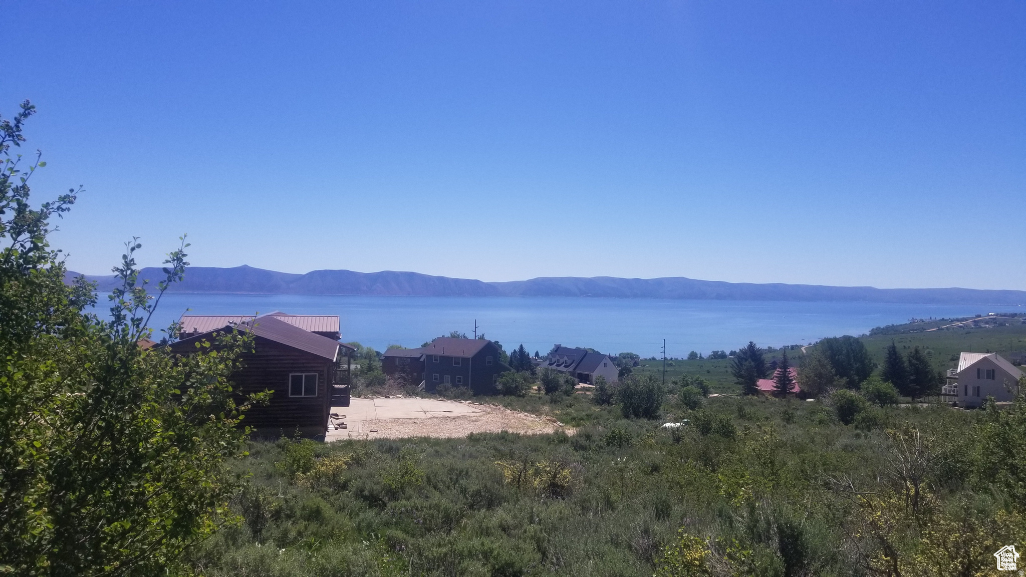 Great corner lot with amazing views of Bear Lake and a nice gradual slope. The lot is just minutes away from Bear Lake West amenities that include a swimming pool, hot tub, discounted golf, beach access, tennis/pickleball courts, and a restaurant. The lot has great 2 street access in an established and developed neighborhood. See additional information at: bearlakewest.com Information deemed reliable, buyer to verify.
