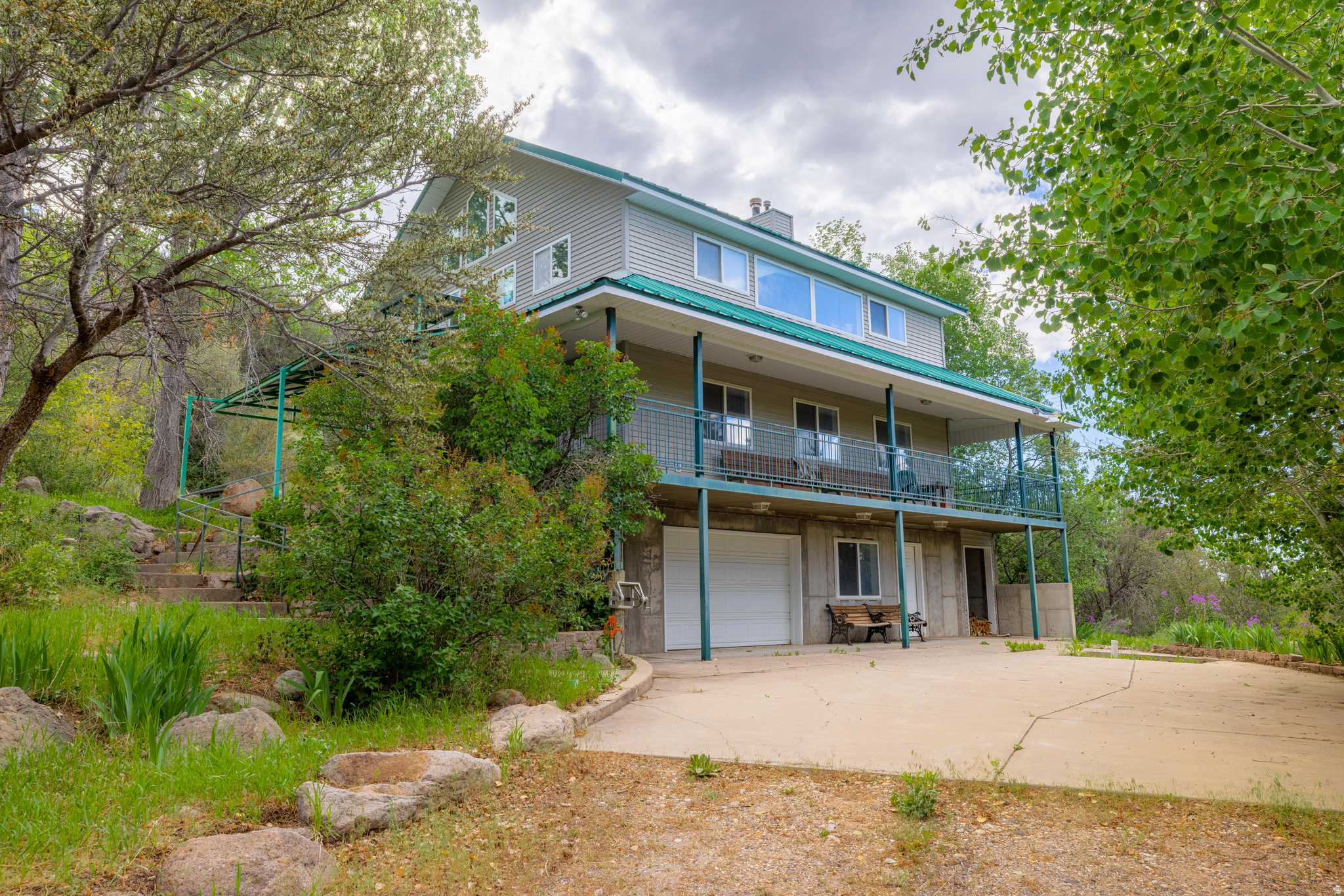 Tucked away on a private, tree-filled lot in the peaceful Pine Valley Townsite, this unique three-level home offers space, flexibility, and a true connection to nature. Situated on a combined 1.89 acres across three parcels, the property provides added privacy, room to expand, and endless possibilities. The home features 2 bedrooms and 2.5 bathrooms, with a thoughtfully designed layout. The lower level includes a garage, half bath, laundry area, and a versatile flex room, perfect for a workshop, home gym, or additional living space. The main level serves as the heart of the home, offering an open concept kitchen, living, and dining area, along with the primary bedroom and a full bathroom. Upstairs, you'll find a second bedroom, an additional bathroom, and a loft area ideal for storage, or a play space. With ample square footage and layout potential, there is room to add up to two more bedrooms if desired. Outside, the property is accessed by a private driveway and is mostly fenced. The terrain is naturally hilly and beautifully wooded with mature trees, creating a serene mountain setting. A grassy clearing offers a usable outdoor space, and an open shed provides extra storage or a great area for projects. A valuable addition to the property is a private well, including a .45 acre foot water right,  enhancing usability and supporting landscaping or future improvements. Located just 45 minutes from St. George and approximately 20 minutes from Veyo where you'll find a gas station, local shops, and dining. This home offers the perfect balance of seclusion and convenience. Pine Valley is known for its quiet atmosphere, scenic beauty, and abundant outdoor recreation, making this an ideal full-time residence, vacation home, or investment opportunity. (All information deemed reliable, buyer to verify all - being sold as-is. All furnishings included).  Must schedule an appointment to view home and/or property.