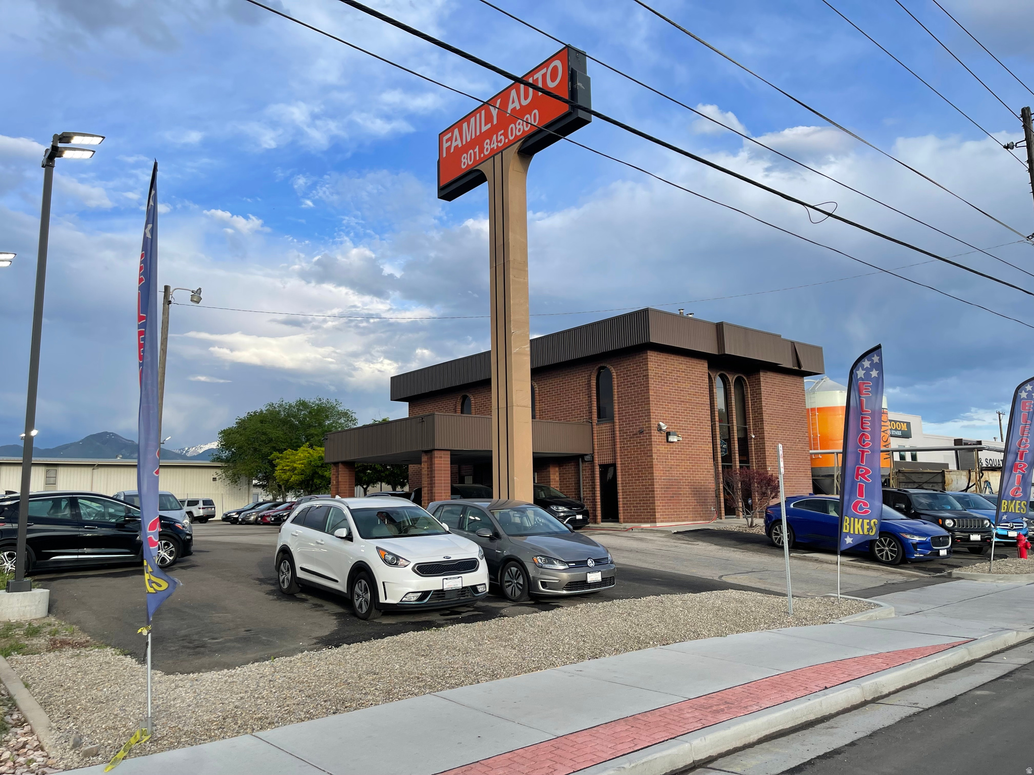 Discover an exceptional commercial property offering versatility in an incredible location. This freestanding, all-brick, two-story building spans 5,670 square feet, with functional 1,890 SF floor plates. Situated on a 0.55-acre lot, it features a two-lane covered drive-through and newly installed electric car charging stations. The main floor boasts a welcoming plaza with private offices and a conference room on the second floor, ideal for diverse business needs.  Located directly across from Utah's largest Costco and just off I-15 between two major exits, with quick access to I-80, this property offers superb visibility and accessibility. Less than a mile from TRAX Central Pointe Station, commuting is effortless. A notable feature is the historic bank vault still in place, adding character and security. Zoned CG - General Commercial, this property permits a wide range of uses, including retail, entertainment, office, residential, heavy commercial, and light manufacturing. Don't miss this opportunity to establish or expand your business in a thriving location.