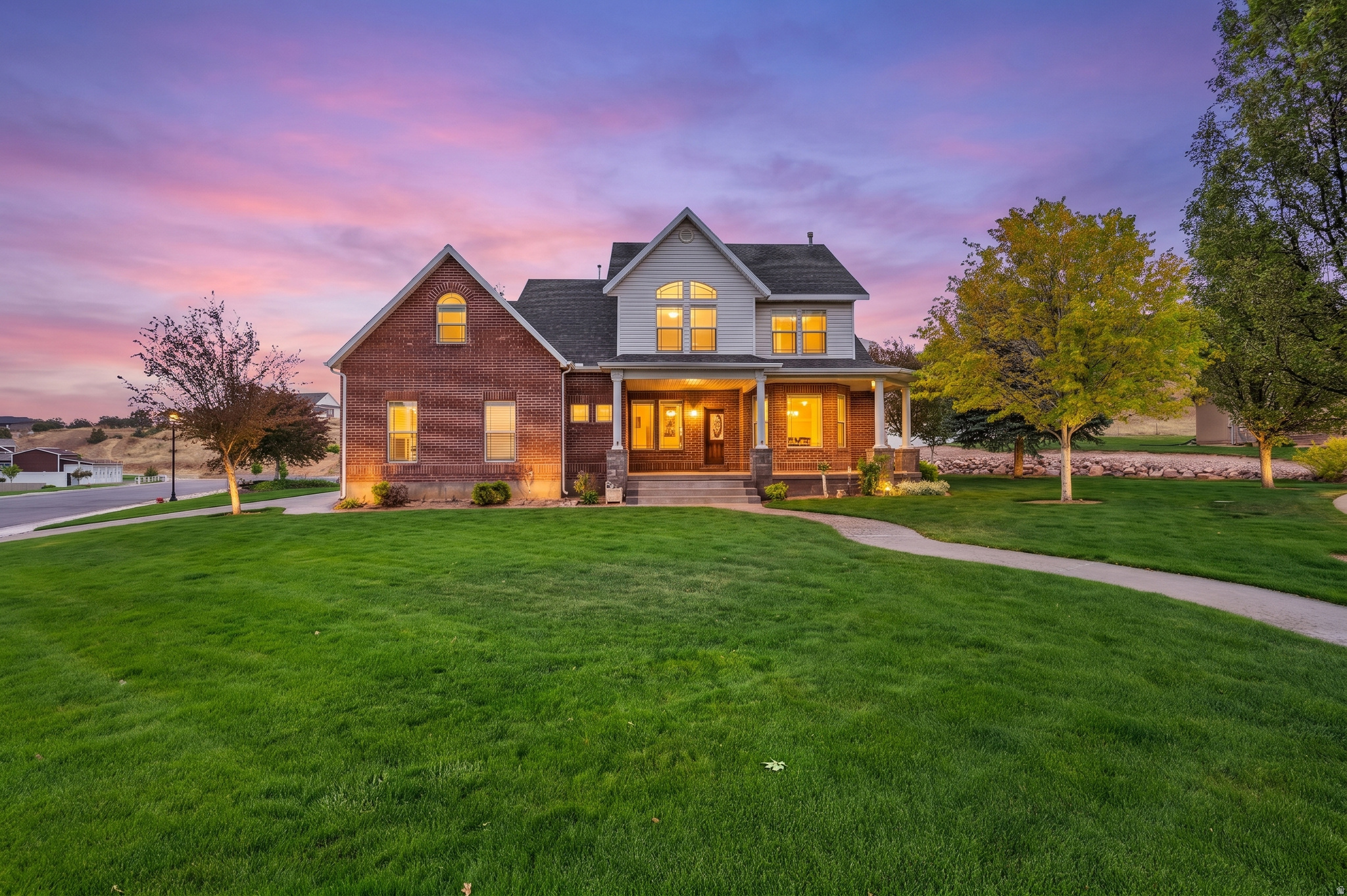 Beautifully designed home with the kind of space, warmth, and setting that is hard to find. Tucked in a neighborhood bordering the high school and football fields, this property offers a unique blend of community atmosphere, stunning scenery, and everyday comfort. Enjoy views of the  mountain skies from the front porch, while the wrap around porch and backyard create the perfect setting for family gatherings, BBQs, summer evenings, and quiet mornings with coffee.  Inside, soaring ceilings, oversized windows, and a grand staircase create an impressive first impression. The spacious kitchen is truly the heart of the home, featuring abundant cabinetry, large gathering spaces, and a layout designed for entertaining, and everyday living. Multiple oversized living and family areas provide flexibility for hosting, relaxing, or spreading out comfortably. The downstairs family room features a floor to ceiling stone fireplace that creates a warm and inviting atmosphere for movie nights and cozy evenings at home.  Upstairs loft and bedroom spaces offer flexibility for growing households, guests, office space, hobbies, or additional gathering areas. The home blends updated features with timeless character, allowing modern functionality while still maintaining warmth and charm throughout. Large windows bring in natural light while framing the surrounding mountain scenery and neighborhood atmosphere.  This property stands out not only for its size and functionality, but for the lifestyle it offers. From Friday night lights nearby to peaceful mornings on the porch overlooking the red cliffs, this is the kind of home built for gathering, growing, and making memories for years to come.