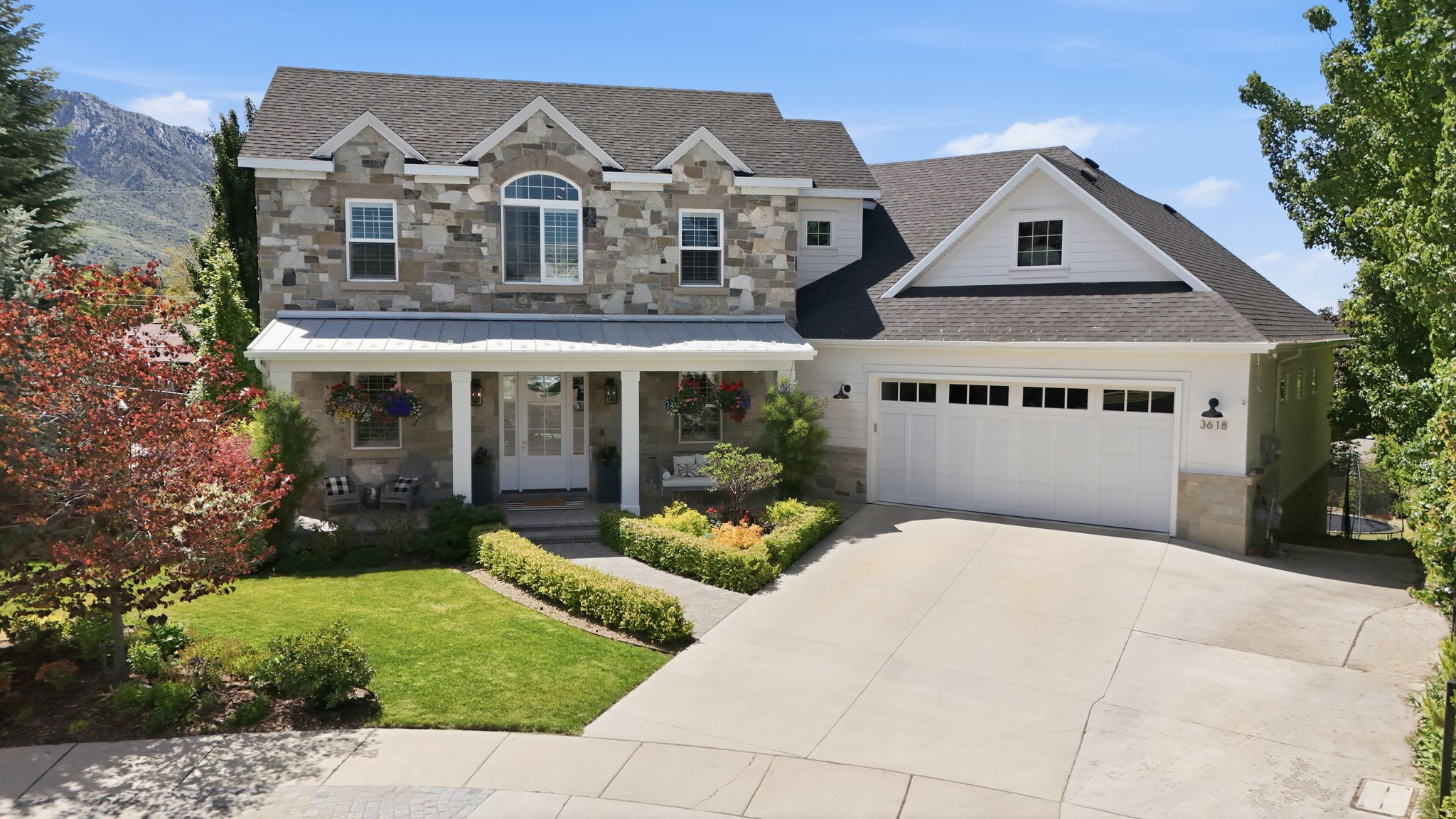 Beautiful custom home in the highly desirable east Millcreek community with stunning Mount Olympus views through expansive walls of windows. Construction completed in 2019, this thoughtfully designed home offers over 5,800 sq ft, 5 bedrooms, 3 full baths, and 2 half baths with spacious open living areas and high-end finishes throughout. Features include a natural stone fireplace, large walk-in pantry, steam shower, walkout basement, RV/boat parking, and seamless indoor-outdoor living with a secluded paver patio, large covered deck, custom stone BBQ, stone fire pit, terraced rose garden, and custom grow boxes. The home also includes a mother-in-law apartment with a separate entrance, full kitchen, and private primary suite-ideal for guests, multigenerational living, or additional flexibility. Unique additional approximately 900 sq ft garage/workshop space below the main garage offers exceptional versatility for a gym, storage, hobbies, or recreational equipment with garage door access directly to the backyard. Incredible location with walkable access to local schools and close proximity to canyons, skiing, shopping, dining, downtown Salt Lake, and the University of Utah.