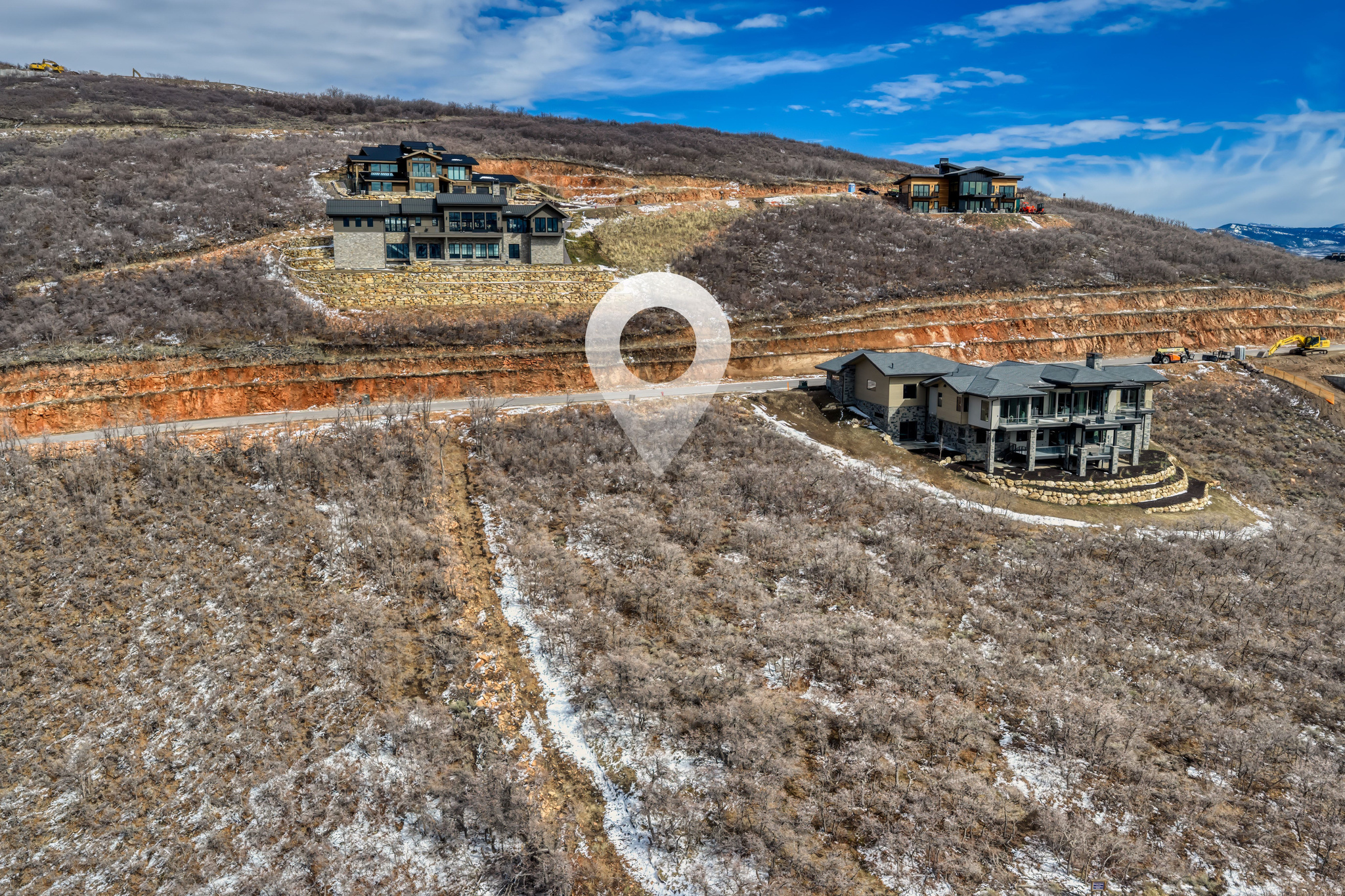 Arguably the most compelling homesite opportunity currently available in Golden Eagle, this coveted downhill lot borders protected open space to the north and sits along one of the community's most protected view corridors--creating rare privacy while capturing sweeping vistas of Jordanelle Reservoir, Deer Valley, Park City Mountain, The Canyons, and the iconic Mount Timpanogos. With no neighboring homes to the north, the setting enjoys an exceptional sense of space and seclusion while preserving the expansive views that define Golden Eagle living.  The coveted downhill orientation allows a future residence to step naturally with the terrain, maximizing view corridors from every level while creating ideal opportunities for walk-out living spaces, expansive decks, and dramatic mountain architecture designed to embrace the surrounding landscape.  Included with the property are stamped and approved architectural plans for a stunning 6,610-square-foot luxury residence, offering a rare opportunity to bypass the lengthy design and architectural approval process and move more quickly toward construction.  Golden Eagle spans more than 600 acres, with over 25% preserved as open space. Residents enjoy miles of private hiking and biking trails and will soon gather at the planned community clubhouse featuring indoor and outdoor gathering spaces, a kitchen, and a fire pit. A restrictive nightly-rental policy helps preserve a quiet residential atmosphere and a true sense of community.  Located just 15 minutes from the new Deer Valley East Village, minutes to Park City's Historic Main Street, and only 35 minutes from Salt Lake City International Airport, this homesite offers an exceptional opportunity to build a legacy mountain retreat surrounded by some of Park City's most iconic scenery.