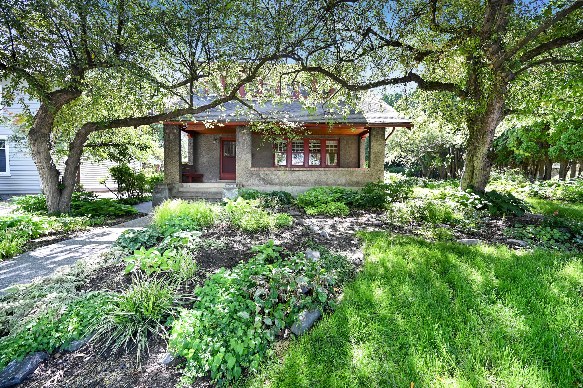Nestled in the heart of one of Logan's most desirable neighborhoods, this charming bungalow offers timeless character, inviting living spaces, and an incredible outdoor retreat. This bright and welcoming 3-bedroom, 1-bath home features beautiful hardwood floors, cozy living areas, and an original character with vintage charm and personality. Thoughtfully preserved details throughout the home create a warm and authentic feel that is hard to find. The true standout is the spectacular yard - a gardener's paradise with mature landscaping, abundant space to entertain, unwind, or cultivate your dream garden. Whether you envision summer gatherings, peaceful mornings outdoors, or simply enjoying the beauty of a spacious and private setting, this backyard delivers endless possibilities. Located in a highly walkable neighborhood near Utah State University, parks, schools, shopping, and dining, this home perfectly blends comfort, charm, and outdoor living.