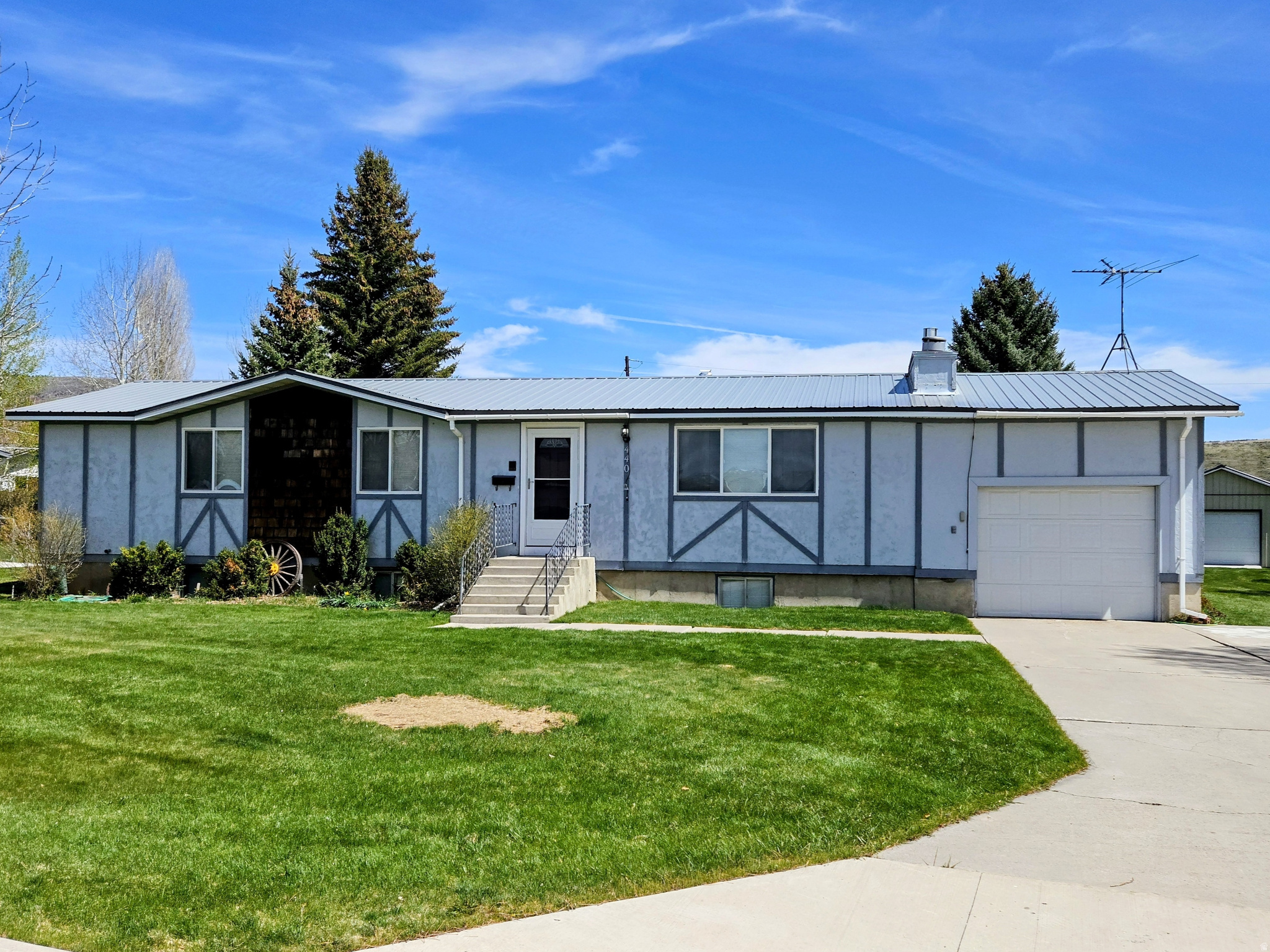 Come take a look at this beautifully updated 5-bedroom, 3-bathroom home situated on a spacious 0.49-acre lot with mature trees, automatic sprinklers, and excellent outdoor storage options. Conveniently backing directly to Adams Park, this property offers a rare combination of privacy, functionality, and room to grow.  The home features an updated kitchen with abundant cabinet space, perfect for everyday living and entertaining. Major mechanical updates include a newer furnace, water heater, and water softener, providing added efficiency and peace of mind.  The spacious basement offers a huge family room with ample storage throughout the home. Bedrooms are generously sized, including two upstairs bedrooms featuring large walk-in closets.  Outside, the property is exceptionally well-equipped with multiple outbuildings. The smaller storage building includes power and a concrete floor, making it ideal for lawn equipment or additional storage. The impressive shop measures approximately 30' x 48' and includes an additional 15-foot-wide lean-to. Oversized shop doors measuring 10' x 14' and 10' x 10' provide excellent access for RVs, boats, trailers, or equipment.  This is a rare opportunity to own a move-in ready property with outstanding shop space, mature landscaping, and direct access to park amenities.  Contact the listing agent today for additional information or to schedule your private showing.