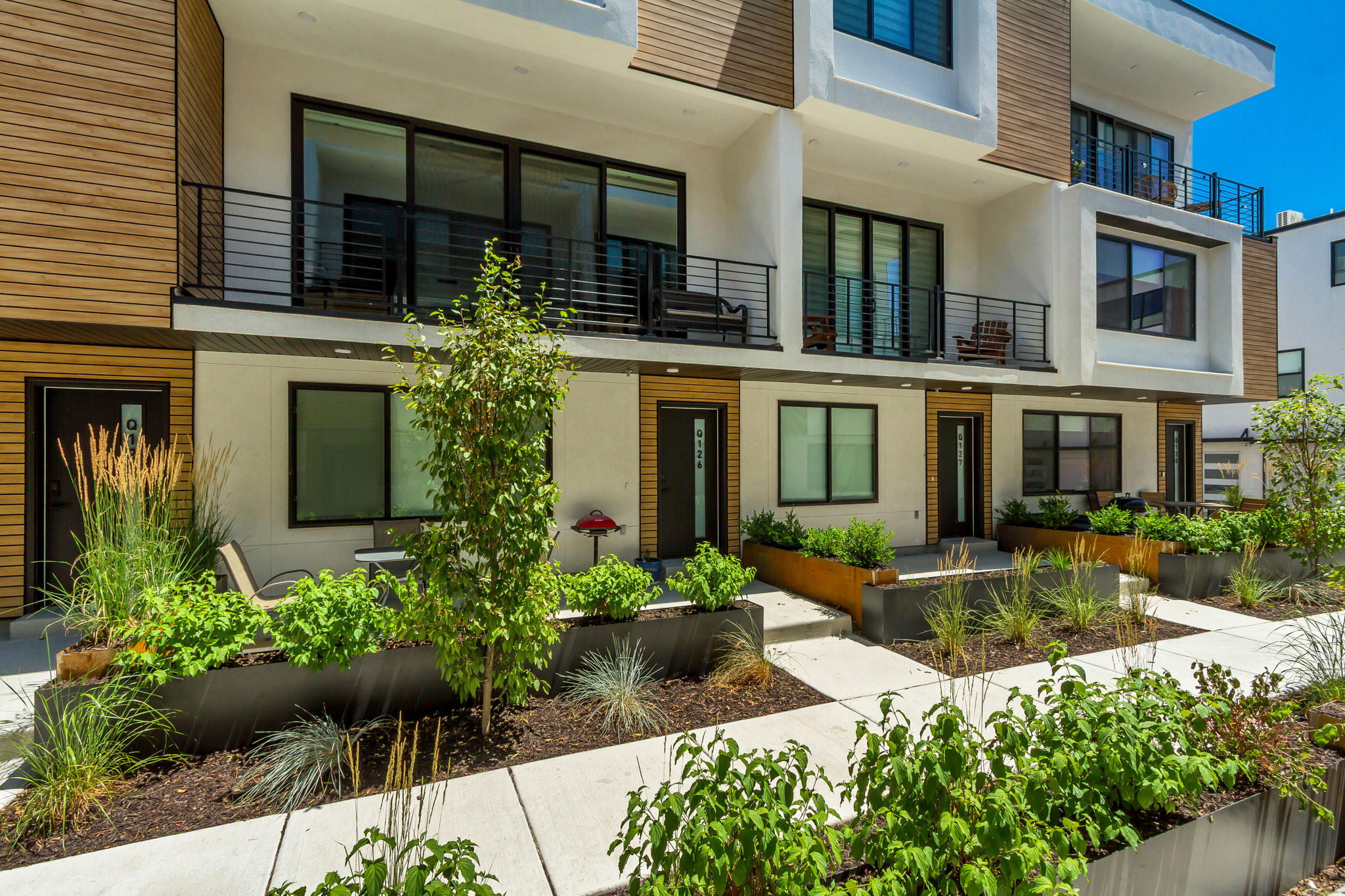 COMMUNITY REINVESTMENT ACT CONVENTIONAL LOAN WITH INTEREST RATES AS LOW AS 5% FOR QUALIFIED BUYERS (ASK FOR DETAILS). FOR THE OPEN HOUSE, PLEASE COME TO THE MODEL LOCATED AT UNIT B104  Welcome to Opus Green. Experience the perfect harmony of modern comfort and environmental stewardship. Opus Green Townhomes offer a range of floor plans, including 2 and 3-bedroom townhomes, designed with meticulous attention to detail. From the spacious great rooms and gourmet kitchens to the tiled showers and open stair railings, every aspect of Opus Green exudes sophistication and elegance for your comfort. This modern townhome community is all-electric with 9'7" cathedral ceilings, tiled showers and tubs with glass doors. Best in class, ductless, wall-mounted mini split air conditioners.  Quartz countertops and a one of a kind floorplan not seen before. This 2 bed 2.5 bathroom oasis will leave you green with envy. The 2 car garage with EV charging station, 1 touch smart home temperature control app and package storage/delivery service "Fetch Package", are just a few more added benefits to this zero emission environmental living townhome. Embrace a life of unparalleled comfort, elegance and fulfillment in the dwelling you've been longing for.