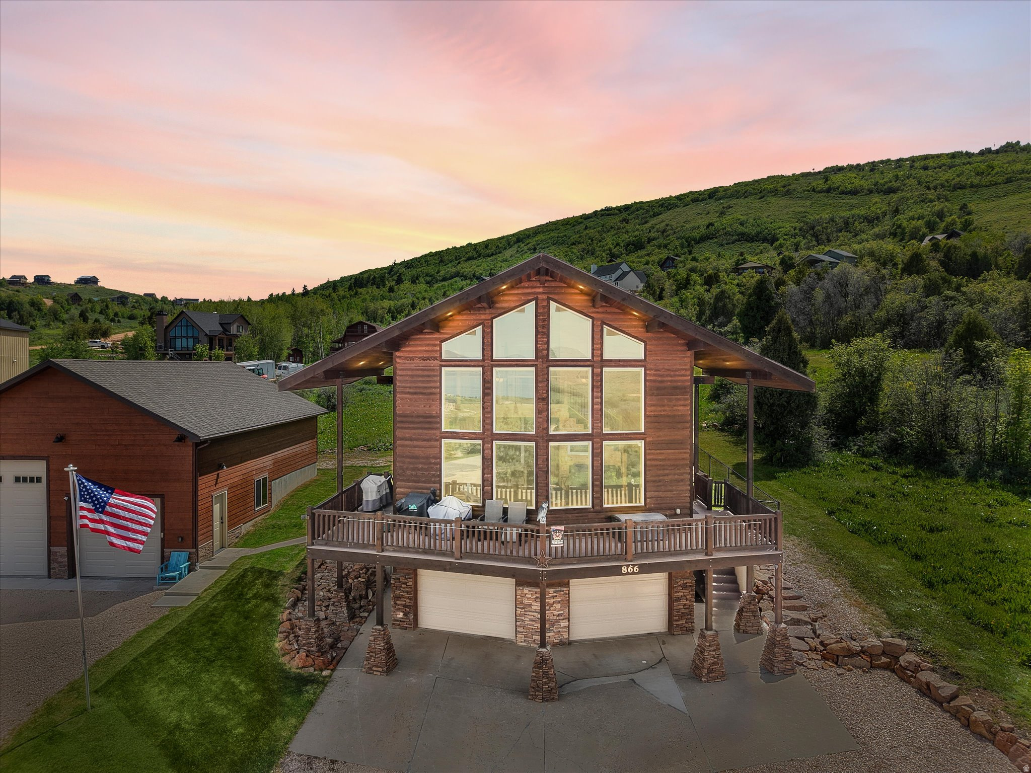 Stunning Bear Lake View Cabin! This beautiful custom cabin offers breathtaking views of Bear Lake through floor to ceiling picture windows that fill the room with natural light.  The open concept great room features vaulted ceilings, warm wood finishes and a cozy stone fireplace, creating the perfect mountain/lake retreat.  Most furniture included! The detached 30'x40' insulated garage has 30 amp RV hookup, 60 amp service, a 13 foot and 9' garage doors, ideal for boats, RVs and all your toys.  The attached garage can easily be converted into additional living space, game room or bunk room. With year round access this home is  perfect for a vacation getaway or year round residence!    Square footage figures are provided as a courtesy estimate only and were obtained from Rich County Assessor .  Buyer is advised to obtain an independent measurement.