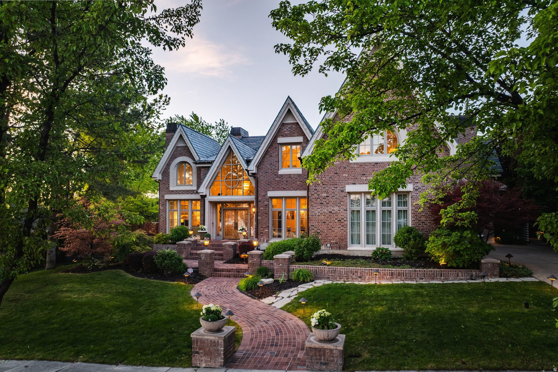 Once-in-a-Lifetime Custom Architectural Home | Private 1.0 acre Oasis in Prestigious Millcreek Nestled in the heart of Salt Lake City, this extraordinary custom residence offers the ultimate in refined luxury - a serene country estate seamlessly integrated into one of the city's most coveted, tree-lined neighborhoods. Designed by renowned architect Kevin Watts and meticulously crafted by Watts Construction, the home rests on a rare, flat 1.0  acre lot providing complete privacy and a park-like sanctuary, all while enjoying effortless access to Sugar House, Millcreek Commons , Canyon Rim, the majestic hiking trails of Millcreek Canyon and Utahs famous ski resorts. This quiet, family-friendly enclave within Millcreek Township is highly regarded for its mature trees, and exceptional walkability to nearby cafes, coffee shops, skating rinks, and boutique amenities. It masterfully blends peaceful suburban charm with close proximity to nature and vibrant city conveniences - a rare and highly sought-after lifestyle. A dramatic suspended spiral staircase greets you upon entry, setting the tone for the home's unparalleled craftsmanship. Soaring ceilings reach up to 30 feet, complemented by walls of windows that flood the interior with natural light. Brazilian cherry inlay hardwood floors, exquisite custom millwork, intricate crown molding, and extensive marble and granite surfaces throughout reflect the highest standards of timeless elegance. The gourmet chef's kitchen is a culinary masterpiece, featuring premium Sub-Zero refrigeration and a Dacor professional range. Five luxurious bedrooms, including three en-suite, and six baths offer spa-like indulgence with steam showers, jetted tubs, Rohl fixtures, and exquisite marble finishes. Signature elements include a private elevator, six fireplaces, radiant floor heating supplemented by furnaces, and advanced Lutron lighting with Control 4 home automation.  Outdoor living is equally spectacular. Stunning full Brick exterior, slate roof, and copper gutter system for free many years of low maintenance living. The lush grounds, adorned with mature trees, outdoor lighting, peonies, hydrangeas, and tulips, create vibrant seasonal beauty. Multiple outdoor patios with elegant trellises promote seamless indoor-outdoor flow, enhanced by a tranquil pond with fountain, and a charming gazebo. Sale includes  the adjacent to the property  with wonderful amenities including a private pickleball court & sport court, a versatile greenhouse ideal for gardening or recreation, and open space perfect for future pool or garden space.  This one of kind property represents a singular opportunity: a private, architecturally significant home that delivers uncompromising luxury, complete privacy, and an enviable location in the heart of Salt Lake City. Truly one of a kind - for the most discerning buyer. Price includes 2 parcels (16-33-128-064 and 16-33-128-063). 2024 Taxes for the additional parcel were approx. $1798
