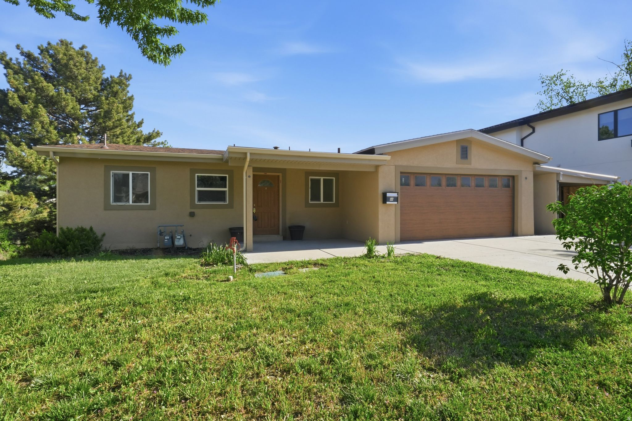 Nearly complete and full of opportunity, this fully remodeled home allows the next owner to step in and choose the final finishes. With 5 bedrooms, 4 bathrooms, 3 kitchens, and 3 laundry hookups, the layout offers incredible flexibility for multigenerational living, income potential, or creative use. Positioned on a quiet, dead-end street, the large and secluded half-acre lot features a rare creekside setting, while large windows and multiple decks maximize views from every level.