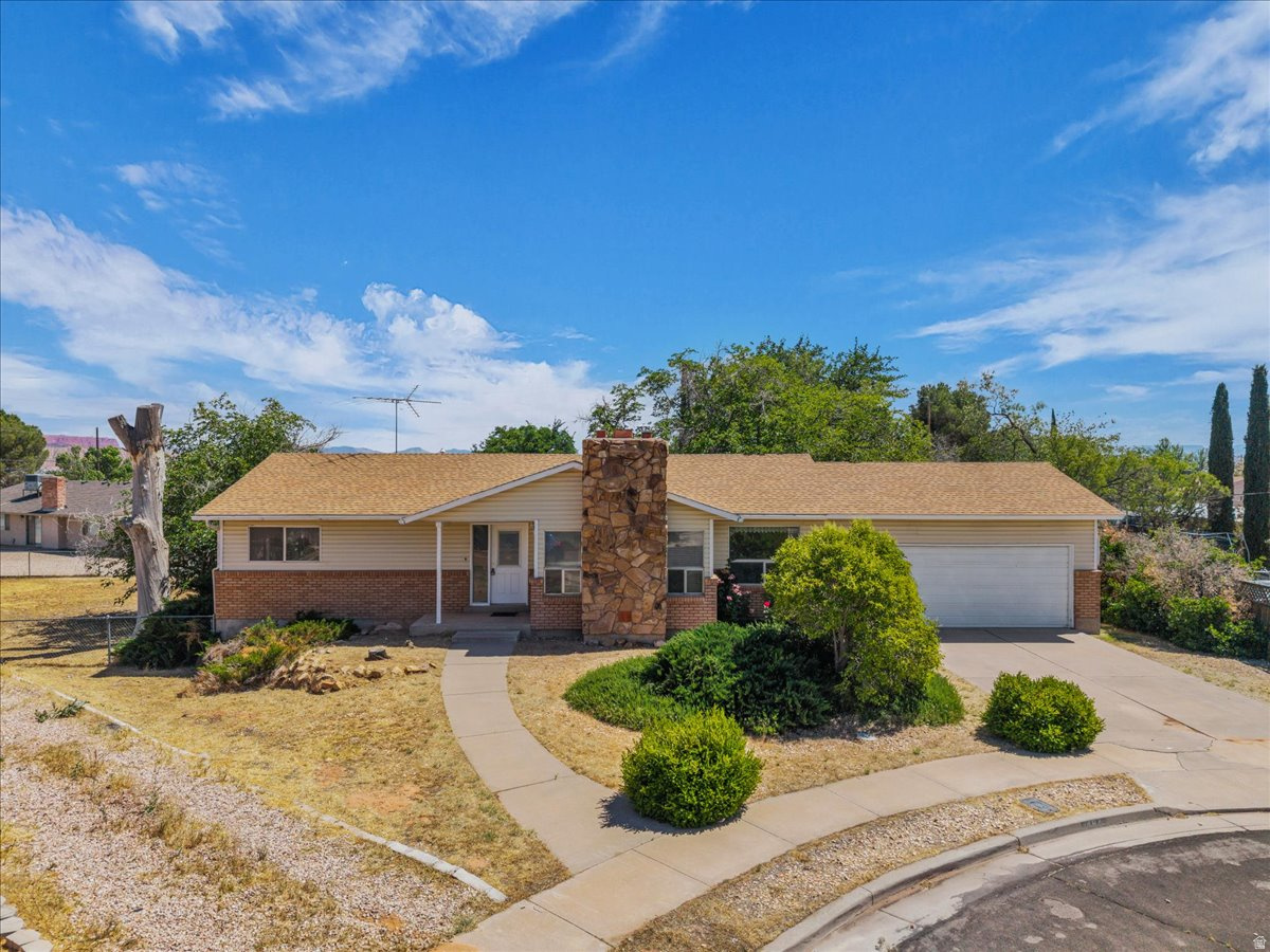 Tucked away in a quiet cul-de-sac, this home offers space, functionality, and recent updates throughout. The walkout basement features an additional kitchen, laundry area, bedroom, and bathroom, creating excellent flexibility for guests, multi-generational living, or added entertaining space. Updated flooring enhances the dining and kitchen areas, while the sliding glass door opens to a large deck perfect for relaxing or hosting gatherings. The spacious living room showcases vaulted ceilings and a cozy gas fireplace, creating an inviting atmosphere filled with natural light. Additional highlights include a two-car garage and a roof that was replaced approximately seven years ago.