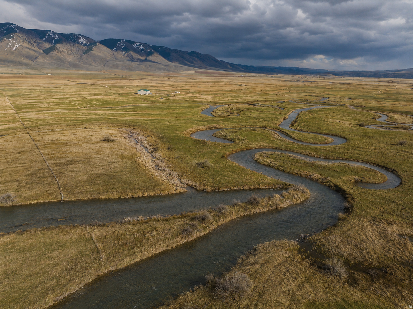 Beautiful Bear Lake County! Thomas Fork River Ranch! 80 acres, 30'-40' wide year round creek/river, 58 shares of irrigation, and a massive 6,000 sq ft metal building, partially residentially finished. The 60'x100' building has cement floor, wood-burning stove, and some framing for residential rooms, as well as 4" plumbing pipes laid in the floor (was to be a 6 bed/3 bath w/kitchen main floor layout), with plenty of height for a second story above! Interior of building being used for storage at the moment. Currently powered by large generator. The year-round accessible road makes this a beautiful future primary residence, or an off-grid retreat to visit in any season, with 80 acres of your own lush, irrigated land surrounding you! The views of the mountains to the east can't be beaten. Thomas Fork Creek flows year round through the property, providing great stock water and fishing right out your backyard! Land is fully fenced, and includes TWO great culinary wells w/pumps, park model home (live there while finishing the bigger building!), corral, a loafing shed, and more! Immense value for all of the acreage, water rights, and numerous improvements. The location is ideal for a recreational residence, putting you 45 minutes from the beautiful beaches of Bear Lake, 30 minutes from the mountain getaways of Star Valley and less than 2 hours from Jackson Hole, the gateway to the Tetons and Yellowstone! Come check out your gorgeous Raymond/Geneva, ID homestead today!
