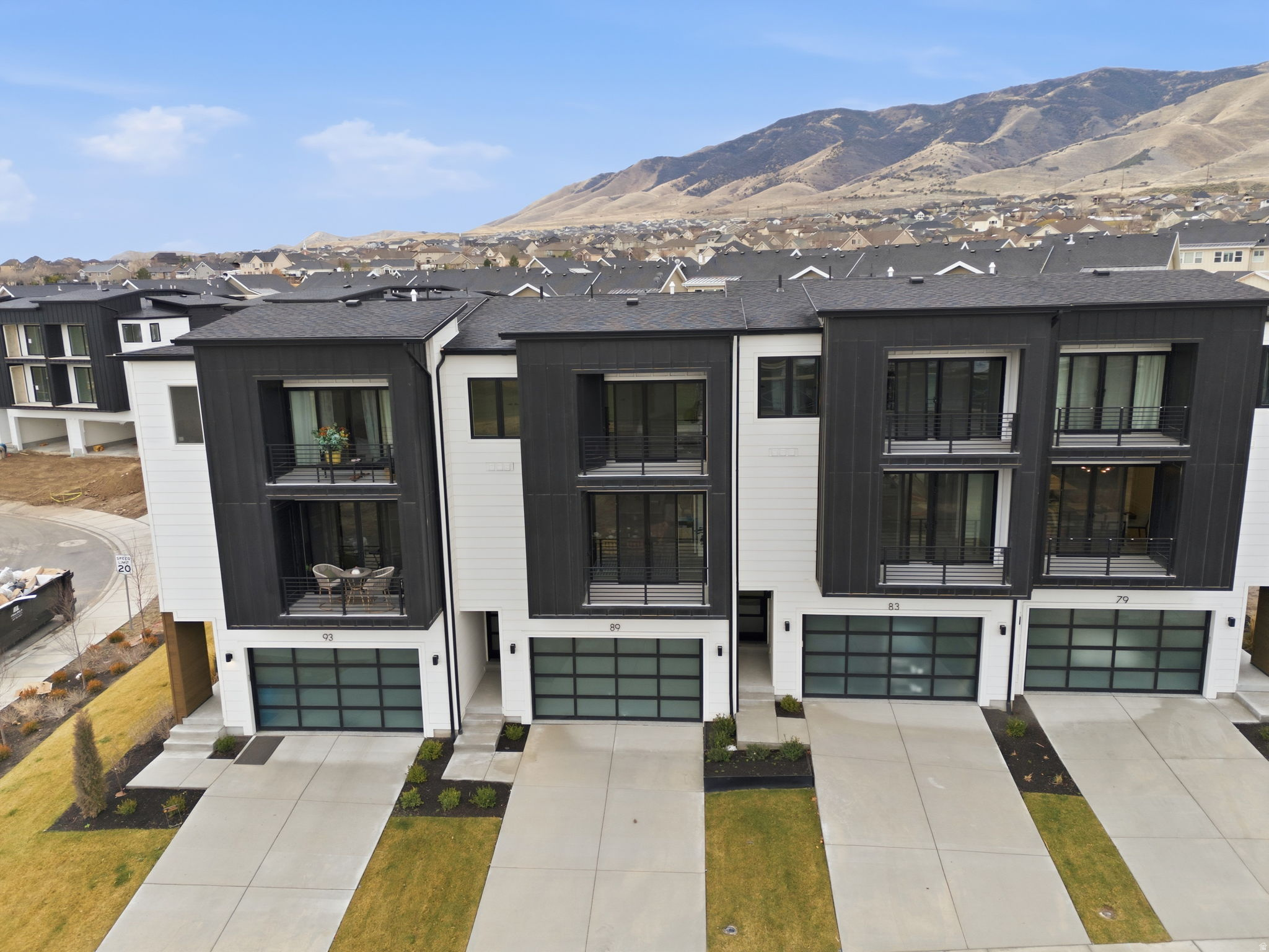 ** The model home is located at 64 Watson Dr. It is open Monday through Friday 11:00 am- 6:00 pm and Saturday from 10:00 am to 5:00 pm. ** We have 2 and 3 bedrooms of this model available at the same price. Experience elevated living in this stunning three-story luxury townhome located on the TalonsCove Golf Course and just moments from Utah Lake. Nestled in a prestigious resort-style community, this home offers the perfect blend of luxury, recreation, and scenic beauty. The second floor showcases a bright open-concept layout with a spacious kitchen, dining, and living area. Floor-to-ceiling windows on both ends fill the space with natural light, creating an inviting and airy environment perfect for entertaining or relaxing.  This exceptional HOA community offers incredible amenities including a year-round natural heated mineral pool fed by local hot springs, a second outdoor swimming pool, two clubhouses with workout facilities and event space, and a private boat dock marina on Utah Lake. Residents also enjoy a large pavilion for hosting gatherings, multiple parks and playgrounds, and miles of connected walking and nature trails throughout the community.  The home itself is filled with premium and thoughtful upgrades including semi-custom soft-close cabinetry, 3 cm quartz kitchen countertops, a vent above the microwave, and high-end window and sliding glass door packages that enhance the home's modern design. The staircase is wider than standard homes and features a large statement window above the stairs that fills the space with light and adds to the luxurious feel.  Additional upgrades include 8-foot doors throughout, custom lighting, extra can lighting with ceiling fan wiring, soundproof walling in the toilet area for added privacy, internet access points installed in the walls, and plumbing for a water softener. The tankless water heater provides efficiency and convenience.  The garage is finished with durable epoxy flooring, an aluminum and glass garage door, added lighting, and a security camera for peace of mind.  Enjoy luxury living just steps from TalonsCove Golf Course and minutes from the water, where resort-style amenities, scenic surroundings, and modern design come together to create an exceptional place to call home.