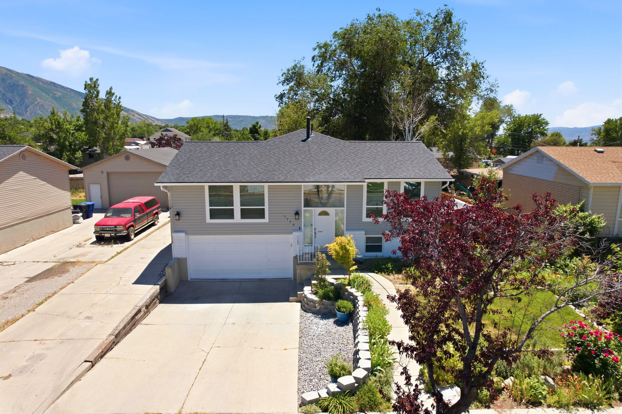 Beautifully updated Sandy home featuring 4 bedrooms, 2.5 bathrooms, RV parking, mountain views, and exceptional outdoor living spaces. The spacious main level offers an open flow between the kitchen, dining, and living areas, highlighted by a cozy gas fireplace and abundant natural light. The kitchen features granite countertops, stainless steel appliances, ample cabinetry, and bar seating.  The primary suite includes a walk-in closet plus additional storage, while the fully finished lower level provides flexible space for bedrooms, a home office, gym, hobbies, or recreation.  Step outside to enjoy the expansive covered deck with ceiling fans and stunning Wasatch Mountain views. The fully fenced backyard offers mature shade trees, a firepit area, swing set, dog run, storage shed, and plenty of room to entertain, play, or relax. The extended RV/boat parking provides space for all your toys.  Major updates include a newer roof, furnace, and water heater. Additional highlights include a large indoor storage/workshop area behind the garage, automatic sprinklers, mature landscaping, and a convenient Sandy location close to parks, shopping, dining, schools, and commuter routes.  Buyer to verify all information, including square footage.
