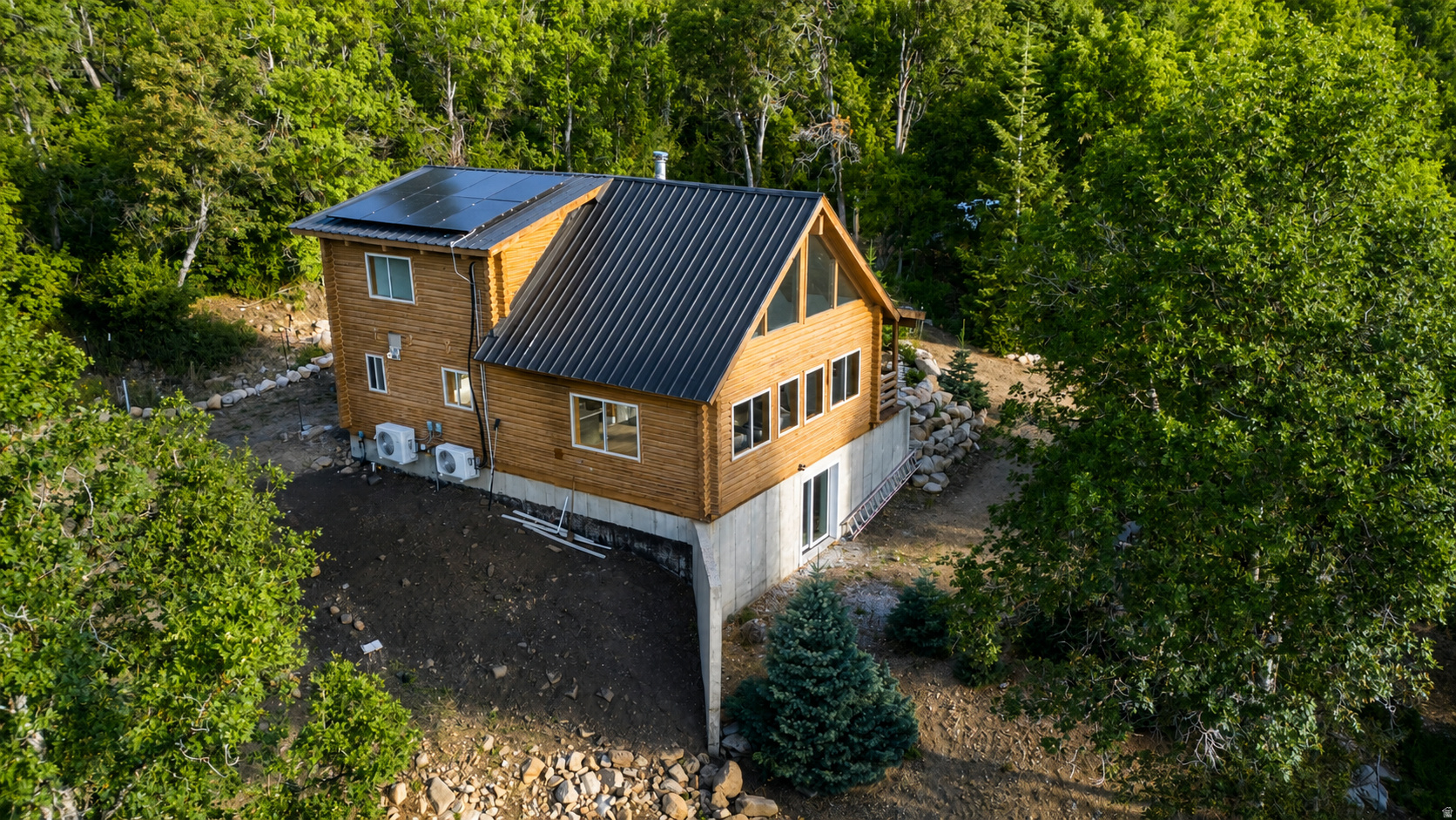 Escape to true off-grid luxury in the gated Upper Whittemore community, where this fully renovated 3-bedroom, 3-bath log cabin sits privately on 3.5 wooded acres just 30 minutes from downtown Springville, offering mountain views, mature pines and scrub oak, and a seasonal stream that runs like a small rushing river each spring; inside, vaulted ceilings and exposed pine beams frame beautiful wood floors and a completely reimagined kitchen with new cabinetry, while each level offers its own bedroom and bath for flexible living, sleeping, or guest space, and a spacious hidden storage area beneath the basement bedroom adds rare extra square footage; the property runs on a new gas forced-air furnace, mini-splits, and an electric fireplace for comfort in every season, with a 13,000-watt generator currently powering the home and a recently installed 8-panel, 8,000-watt solar array (with batteries), ready to bring it fully self-sufficient, plus Starlink internet already up and running; a private cistern-fed water system, laundry hookups, and thoughtful pre-wiring for future built-in bunks round out a cabin that blends rugged mountain character with genuine modern comfort, all just past a gated entrance into one of Springville Canyon's most secluded settings.