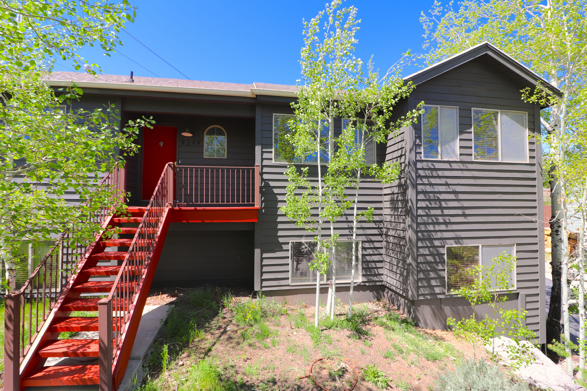 This 4 bedroom, 3 bath home blends comfort, functionality, and year-round recreation in a cul-de-sac setting. The open living area is filled with natural light thanks to the home's south-facing orientation and features a stone accented fireplace that creates a warm and inviting feel. The large garage includes an additional storage room, ideal for outdoor gear and tools. Situated on a spacious uphill lot, the property offers room to enjoy the outdoors. Located in the Park City School District. Enjoy quick access to the trail system at Parley's Lane Loop, recreation at Woodward Park City, shopping and restaurants at Quarry Village, all while being just a short drive to Park City Main Street and ski resorts, plus Salt Lake International Airport.