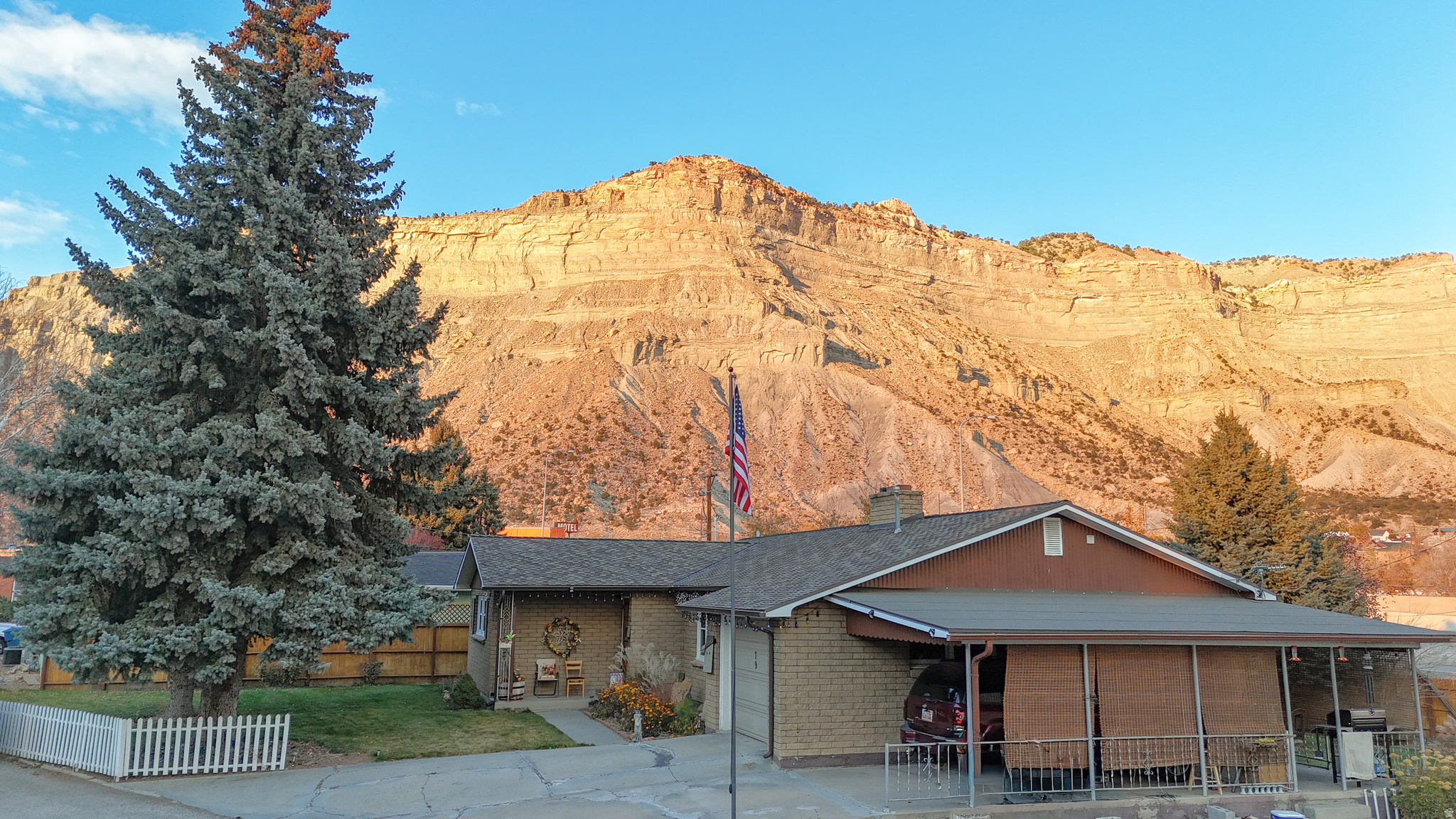 Motivated Seller! Homes with this kind of setting and character do not come along often. From the moment you arrive, you can feel the history and pride in this charming brick residence, set against the dramatic backdrop of Balanced Rock and the cliffs north of Helper. The landscaping frames the home beautifully, giving it a welcoming, established presence that only grows more appealing as you explore further.  Step inside and you are greeted by a warm, comfortable living room centered around a classic fireplace, the kind of space that has likely hosted decades of conversations, celebrations, and quiet evenings. The flow into the formal dining area makes the home ideal for gatherings, large or small. Thoughtful updates have already been taken care of, including a roof replacement and vinyl windows on the main floor.  Furniture included! Downstairs, the basement offers exceptional storage and flexibility. With plumbing and both gas and electric dryer hookups already in place, the space could easily support a second kitchen or hobby area.  Outside, the property continues to impress. You'll find a one-car attached garage, a one-car carport, and an additional detached garage, giving you ample room for vehicles, tools, and projects. Secondary water is provided through the Bryner-Hansen ditch for added convenience.  Even better, this sale includes a second parcel (Tax ID 1A-0334-0000), adding .21 acre that features a workshop and shed, plus another workshop in the basement. Whether you need storage, workspace, or room to expand, this property has options.  Priced below a recent appraised value and offering so much potential, this home is one you will want to see quickly. Homes with this combination of charm, views, and versatility are hard to find. Square footage figures are provided as a courtesy estimate only.  Buyer is advised to obtain an independent measurement.