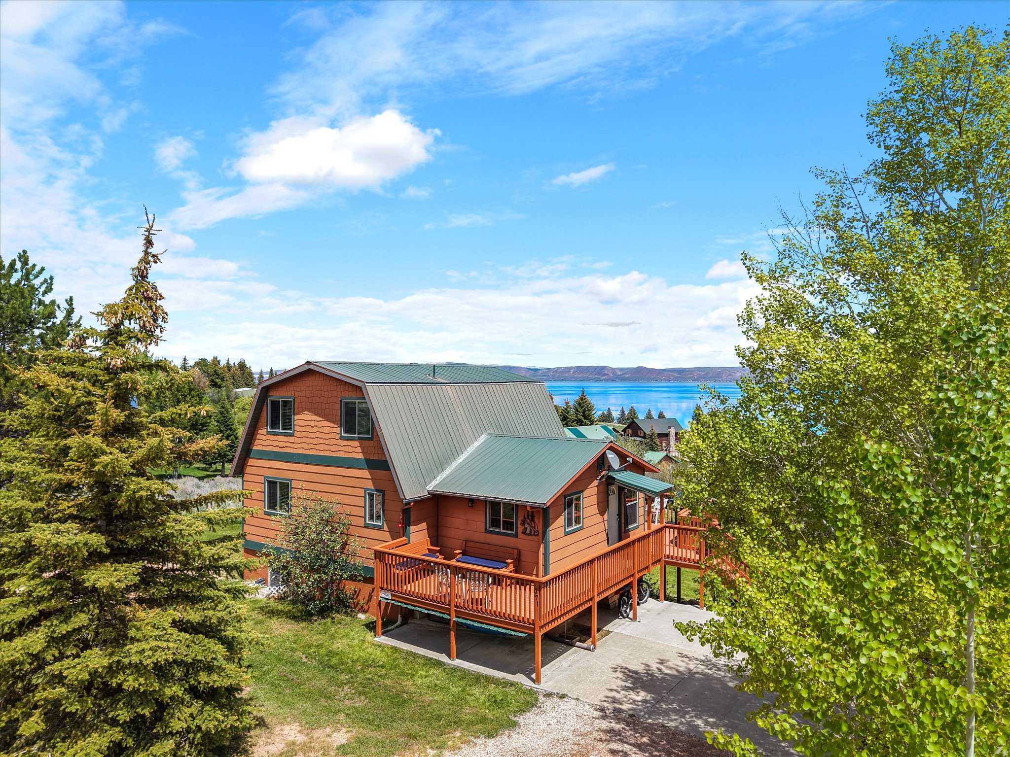 Experience the best of Bear Lake West with this beautifully updated home, perfectly situated near the clubhouse, golf course, swimming pool, tennis and pickleball courts, Cooper's Restaurant, and the community's private beach. Enjoy breathtaking lake views from large east-facing windows, ideal for sunrises and relaxing with family and friends. A newly added west-facing deck offers serene mountain views, additional outdoor space, and a perfect spot for entertaining in the shade. Inside, the home boasts a fully upgraded kitchen with new cabinets, backsplash, and granite countertops. Other improvements include new windows, siding, and carpet, making this home move-in ready. Whether it's summer by the lake or winter at Beaver Mountain Ski Area, this home offers year-round resort living. Offered furnished and designed for comfort, don't miss the chance to own a home in Bear Lake West's most desirable location with unbeatable lake and mountain views.   Square footage figures are provided as a courtesy estimate only and were obtained from Bear Lake County assessor.  Buyer is advised to obtain an independent measurement.