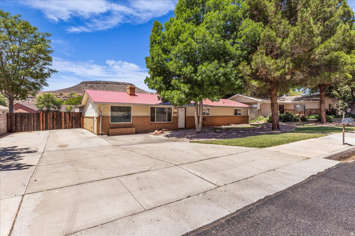 RARE DOWNTOWN ST. GEORGE PROPERTY WITH AN ATTACHED ADU, INCOME POTENTIAL, AND MULTI-GENERATIONAL LIVING OPTIONS! This versatile property functions beautifully as a primary residence, house hack, investment property, non-conforming duplex, or mother-in-law suite setup. The main home offers 3 bedrooms and 2 bathrooms, while the attached ADU includes 1 bedroom, 1 bathroom, a full kitchen, living room, and separate entrance, creating excellent flexibility for rental income, extended family, or guests. Recently renovated and truly move-in ready, the property includes a new roof, new HVAC system, new electrical panel, new tile flooring throughout, granite countertops, new cabinets, backsplash, new appliances, and more. Outside, you'll find a huge RV parking area, a large backyard, mature landscaping, and large shade trees that enhance both curb appeal and outdoor enjoyment. Enjoy beautiful views of the surrounding Southern Utah red rock landscapes, all with NO HOA restrictions. Premier location near historic downtown, Ancestor Square, shopping, dining, entertainment, and local attractions. Properties offering this combination of location, versatility, updates, parking, and income potential are hard to find. Buyer/buyer's agent to verify all information.