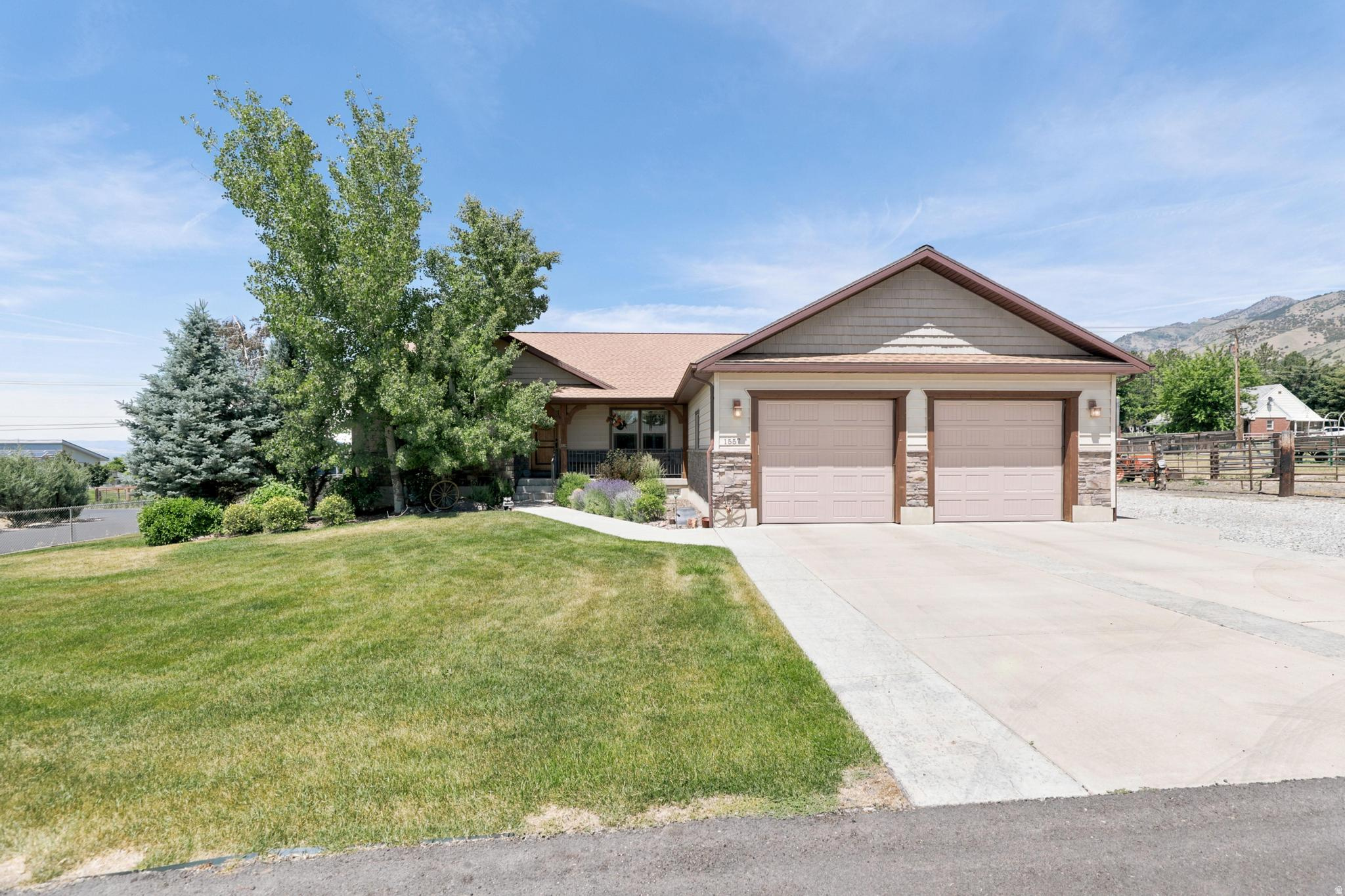 This North Logan home offers nearly 3,800 sq ft on a fully fenced 0.81-acre lot. The 5-bedroom, 3-bath residence features main-level living with an open-concept kitchen and living areas, plantation shutters, wood trim accents, a cozy gas fireplace, and a convenient upstairs laundry room. The walkout basement includes a full secondary kitchen, an additional laundry area, two entrances, and abundant natural light-ideal for guests or extended family. The covered back deck provides perfect outdoor entertaining space. Eco-friendly solar panels help reduce energy costs, while the yard is maintained with dedicated irrigation water. Storage options are available in the basement, garage, and outside shed. Parking is ample with a deep 2-car garage and large RV parking. Located in a highly desirable neighborhood, this property combines spacious living, outdoor enjoyment, and practical features.