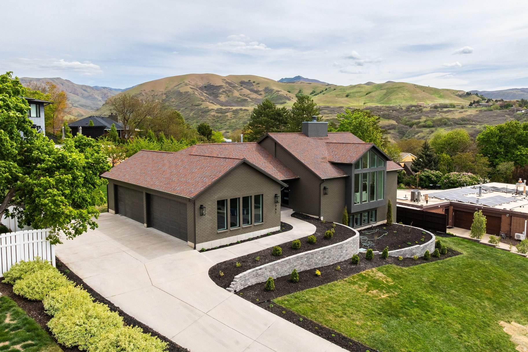 Immaculately reimagined and effortlessly elegant, this stunning home blends timeless design with luxurious modern living. A truly rare offering featuring main-floor living, sweeping valley views around the house, an open-concept floor plan, and an impressive FOUR-car garage. Every inch of this home has been thoughtfully curated with upscale finishes and quality craftsmanship that today's buyer will appreciate.  The heart of the home is designed for gathering and entertaining, showcasing vaulted ceilings in the living room, a chef's kitchen with a striking 48" gas range, 48" refrigerator, quartz countertops, custom cabinetry, and a beautiful butler's pantry for added prep and storage space. Convenient mudroom-style lockers create the perfect drop zone for busy everyday life.  Retreat to the serene primary suite featuring vaulted ceilings, a spa-inspired bathroom with marble floors, soaking tub, and elevated finishes that feel straight out of a luxury resort. Additional convenience includes a dedicated setup for a stackable washer and dryer.  Step outside to the expansive new deck, perfectly positioned to take in the mountain views and ideal for relaxing evenings or entertaining guests. Major updates have already been completed for peace of mind, including new HVAC, new water heater, 220V service to the deck for hot tub and EV for garage. New appliances, premium wood flooring, and fully landscaped grounds.  Fully permitted remodel. Move-in ready, and designed to impress, this is the one buyers have been waiting for.