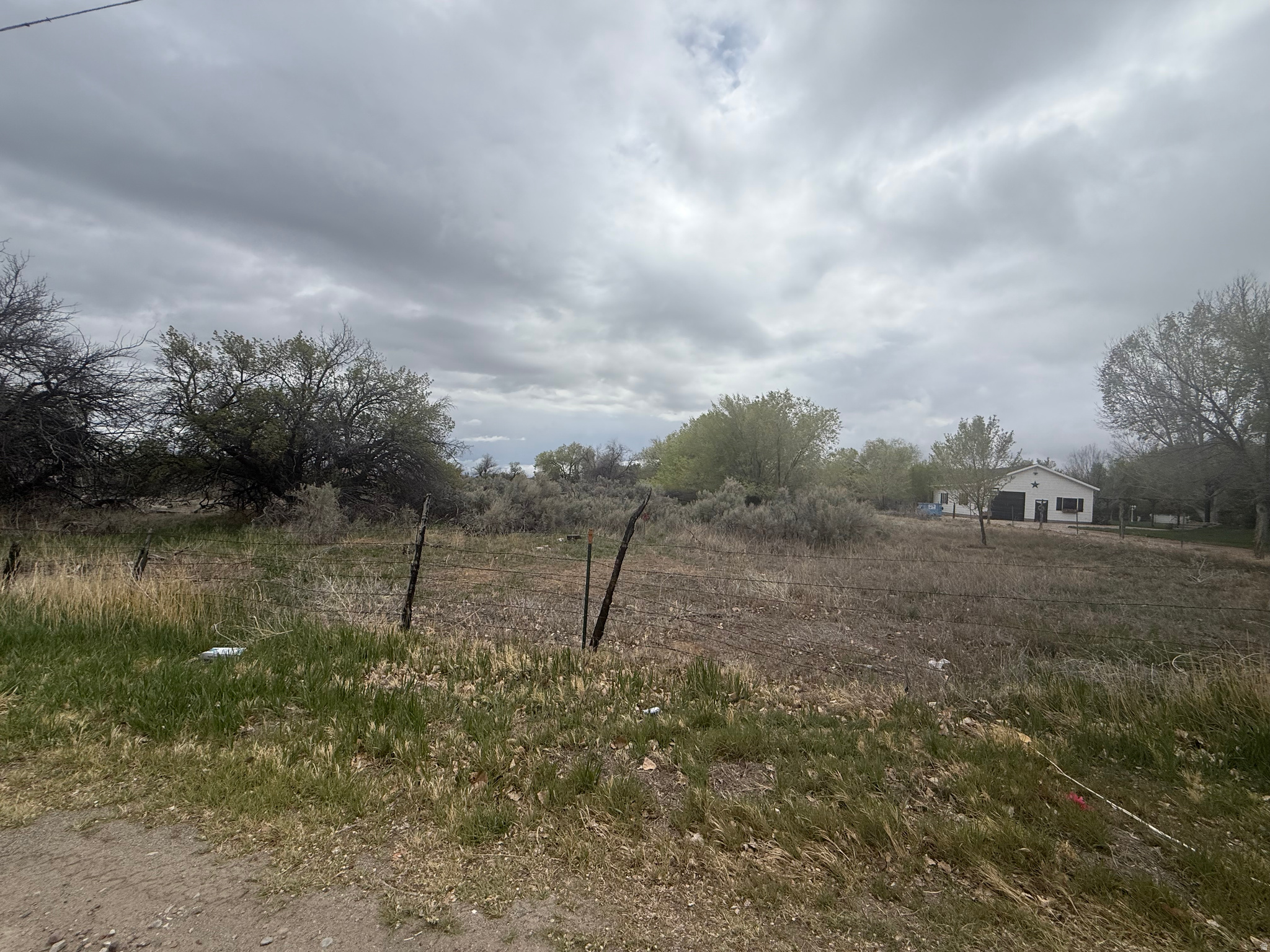 Discover a rare opportunity to own 7.97 acres of prime land in Maeser, Utah, surrounded by wide-open country views and peaceful rural charm. This versatile property offers the perfect balance of seclusion and accessibility, making it ideal for a private estate, flag lot development, or long-term land investment. The property includes valuable irrigation water shares. The shares consist of 10.87 Ashley Valley Reservoir Shares, 0.444  Central primary shares and 1 S-Stock share in the Central canal, which together provide irrigation water through the companys delivery system. Primary shares represent the base water supply, while S-Stock serves as supplemental water, enhancing the property's agricultural usability and long-term value. With one water connection available on 1500 North, infrastructure is already partially in place to support your vision. Adding even more flexibility, the sale includes a second parcel (040840019) located at 2329 W. 1400 N., offering additional opportunities for expansion, building, or potential resale. Whether you're looking to build your dream home in a quiet country setting or invest in land with strong future potential, this property delivers both space and opportunity in a growing area of the Uintah Basin. Property data provided as a courtesy estimate only and obtained from county records. Buyer is advised to obtain an independent measurement and perform their own due diligence
