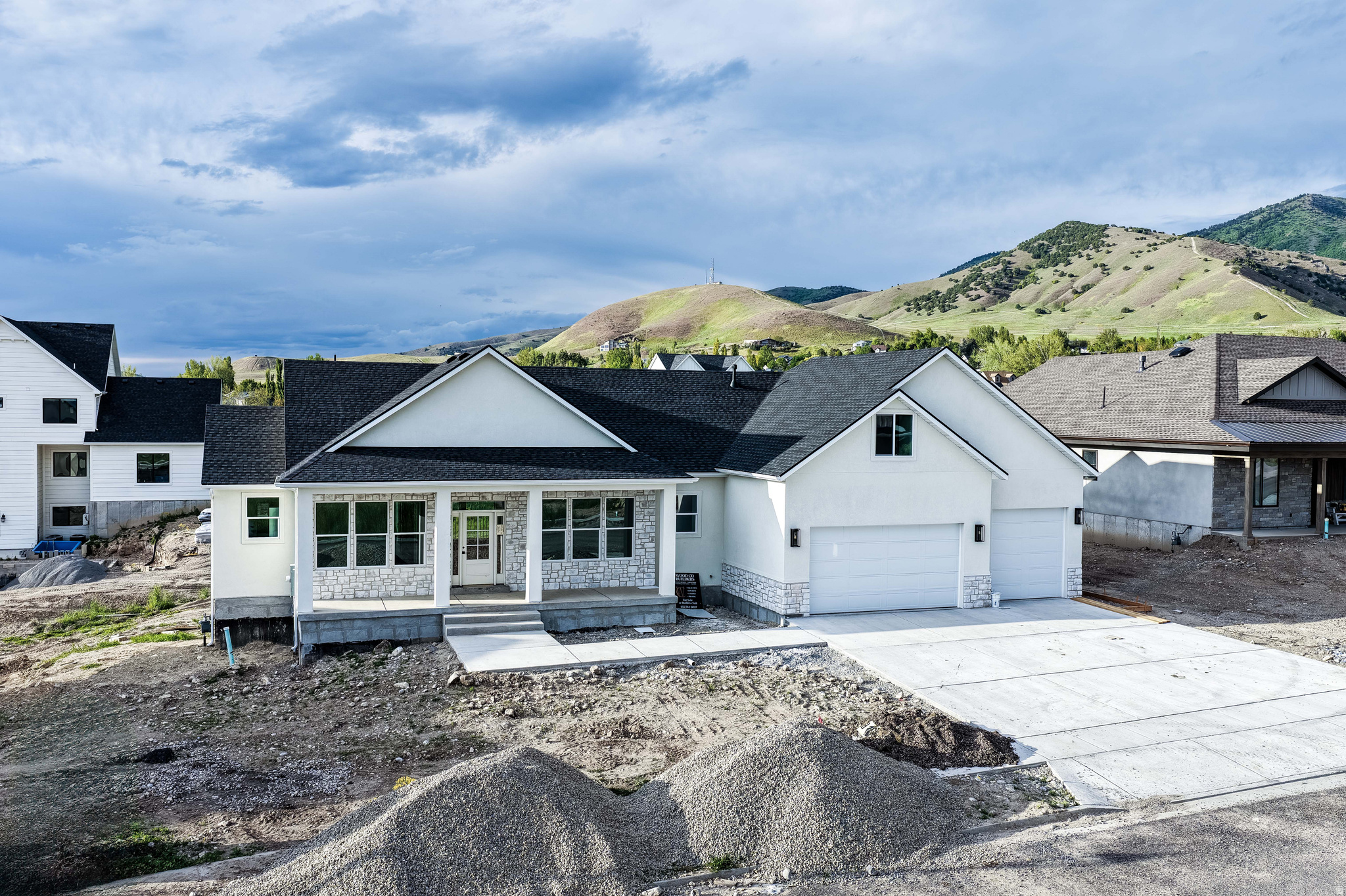 Set in the sought-after Cedar Bluff subdivision, this newly built home by Wood Co Builders blends thoughtful design, quality craftsmanship, and a location that makes it easy to enjoy everything Cache Valley has to offer. Scheduled to be finished in just a couple weeks, the home offers a layout that feels open, comfortable, and functional without wasting space. Check out the flexible bonus room above the garage that's ready for movie nights, gaming, hobbies, or whatever fits your lifestyle best! Covered deck and patio spaces make it easy to take in the valley views and enjoy the changing seasons. The 3-car garage includes one extra-deep bay with room for larger vehicles, storage, or outdoor gear. One of the best parts of this home is the location. Trails leading to Hyde Park Canyon and the Bonneville Shoreline Trail are just a short walk away, while Utah State University is only about 7 minutes from home. Shopping, restaurants, theaters, banking, and everyday amenities are all within a quick 10-minute drive.