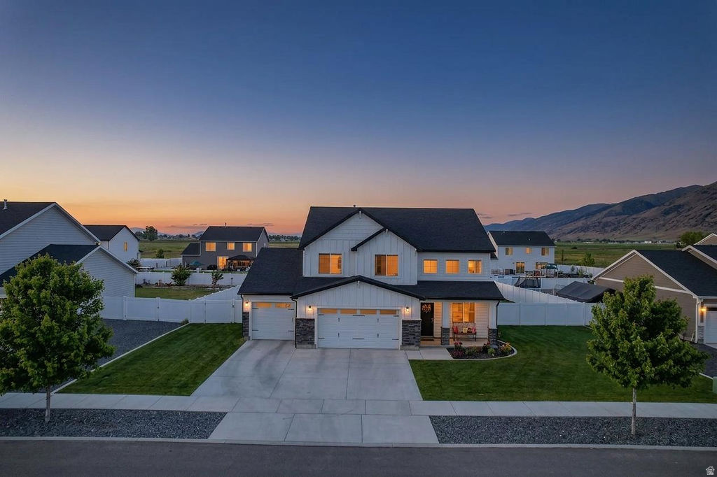 Welcome home to this turnkey, like-new gem nestled in the beautiful countryside of Hyrum. Situated on a spacious .35-acre lot, this property offers the perfect blend of modern comfort and peaceful country living, all surrounded by breathtaking mountain views and the scenic beauty that makes Hyrum such a desirable place to call home.  Step inside to discover a thoughtfully designed floor plan featuring 4 bedrooms, a dedicated office, 2 full bathrooms, a convenient half bath, and plenty of room for family and guests. The heart of the home is the stunning kitchen, complete with abundant cabinetry, generous counter space, and a large walk-in pantry that provides exceptional storage and organization.  The open-concept living areas create a warm and inviting atmosphere, perfect for gathering with loved ones or entertaining friends. Large windows fill the home with natural light while showcasing the picturesque mountain vistas and peaceful surroundings.  Outside, the expansive lot offers endless possibilities for outdoor enjoyment, gardening, recreation, or simply relaxing and taking in the fresh air and beautiful views. The oversized three-car garage provides ample space for vehicles, toys, tools, and additional storage.  If you've been dreaming of a move-in ready home with room to grow, incredible views, and the charm of country living just minutes from town, this exceptional Hyrum property is one you won't want to miss.