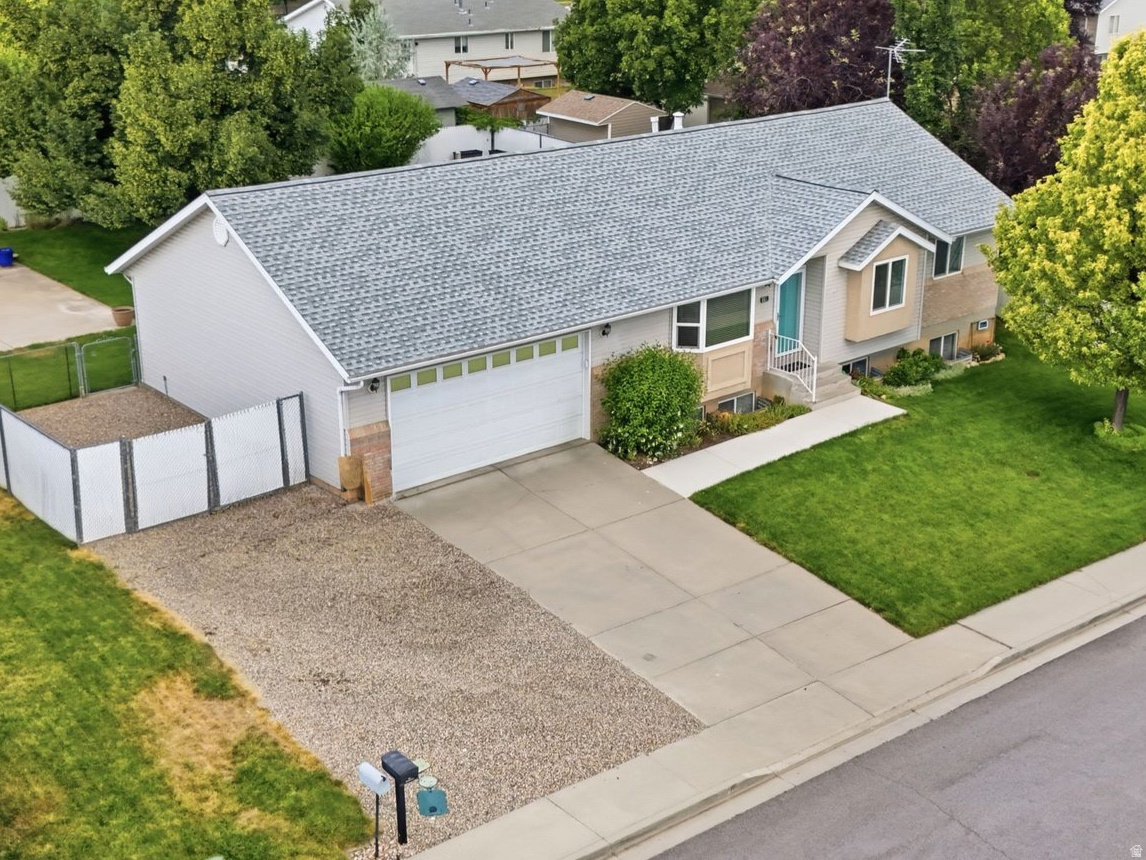 This single-owner home has been cared for down to the smallest detail and it shows. Newer roof & all new windows around 2022 / 2023, new LVP flooring on the main floor in 2024, water heater in 2023, updated paint, new LED lighting, and brand new carpet in the basement June 2026. Primary bathroom shower, flooring and toilet were completely redone in January 2026, basement bathroom was completely renovated just a few years ago and has hardly been used; main floor hall bathroom has new flooring, paint, mirrors and lighting. So many updates have been completed so you can move in without a to-do list! Outside, the yard is built for living, featuring a fully fenced lot with mature trees, lush, well-maintained grass with a  sprinkler system tied into pressurized irrigation, a large patio, shed, and a vegetable garden ready for planting. There's plenty of parking too, with extra driveway space plus dedicated RV parking with a double gate that opens to extend the length of parking space if needed.  Extra features include an attic storage area above the garage with a pull down ladder, lights and flooring, which holds a ton of extra storage; a "Nuvo" eco friendly & compact water softener; an oversized storage room in the basement and a spacious laundry room with ample cabinetry and a sink. Tucked into a quiet, country neighborhood, you're just minutes from I-15, grocery stores and schools, a rare combination of peaceful and convenient.