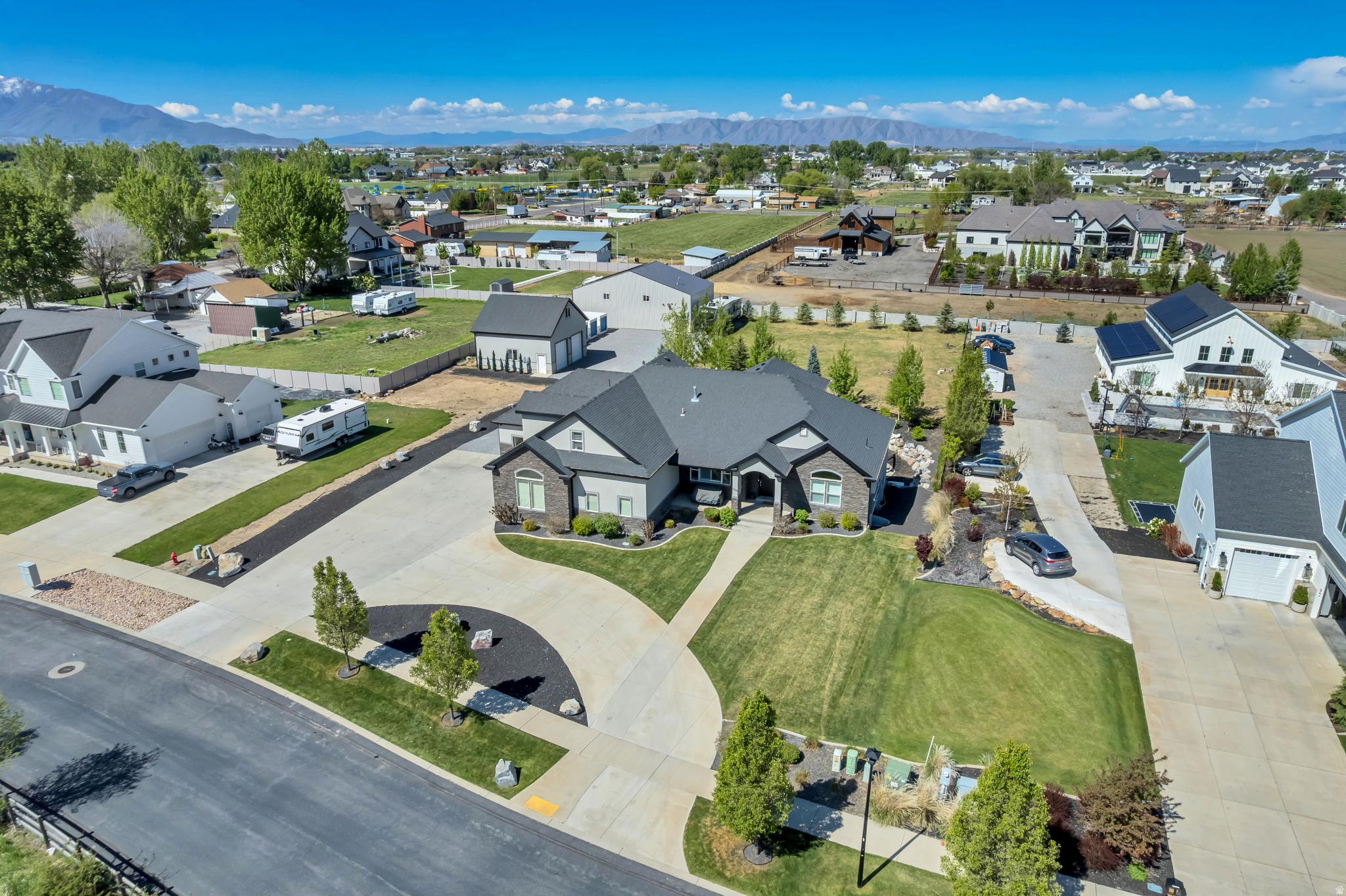 Set on a rare 1-acre lot in highly sought-after Mapleton, this exceptional property offers space, versatility, and endless possibilities. The home features a thoughtfully designed layout with a spacious butler's pantry and a 3-car attached garage, perfectly suited for both everyday living and entertaining. In addition to the main residence, a detached 2-car garage includes beautifully finished living space above-ideal for a home office. The basement includes a separate apartment with its own entrance, for guests or potential rental income. The impressive 1,836 sq ft pole barn has been transformed into a private gym but offers incredible flexibility-envision your own pickleball court, workshop, or recreational space. Step outside to a stunning, professionally landscaped backyard complete with a tranquil waterfall and pond, creating a private retreat right at home. With ample remaining space, the property is perfectly suited for horses, a sports court, or whatever your lifestyle demands. A rare opportunity to own acreage with this level of functionality and finish-this is Mapleton living at its best.