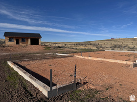 This property in The Reserve at Bear Lake is being sold "AS IS".  Foundation is in place for a 4500 square foot, 6 bedroom 5 bath home with a double garage. The engineered architectural plans are included. It has aa 28 x 38  ADU (Additional Dwelling Unit)  in the back that is framed and ready to finish with 1 bdrm 1 bath, full kitchen, laundry, living room, covered deck, and extra long garage. You can get this finished and stay in it while you build your dream cabin.  Hookups are paid, comes with engineered architectural plans, all permits and building approvals have been done.  The Reserve at Bear Lake offers exceptional resort-style amenities including one of the BEST PRIVATE sandy beaches in Bear Lake, a clubhouse with two swimming pools, hot tub, splash pad, exercise room, sports court with pickleball, tennis, and basketball courts.  Maintained commonareas and  paved roads, and snow removal for year round recreation. SHORT TERM RENTALS ARE ALLOWED making this an excellent opportunity for a vacation home, investment property, or year-round retreat with close access to Bear Lake recreation and direct access to Fish Haven Canyon for ATV and Snowmobile trails.