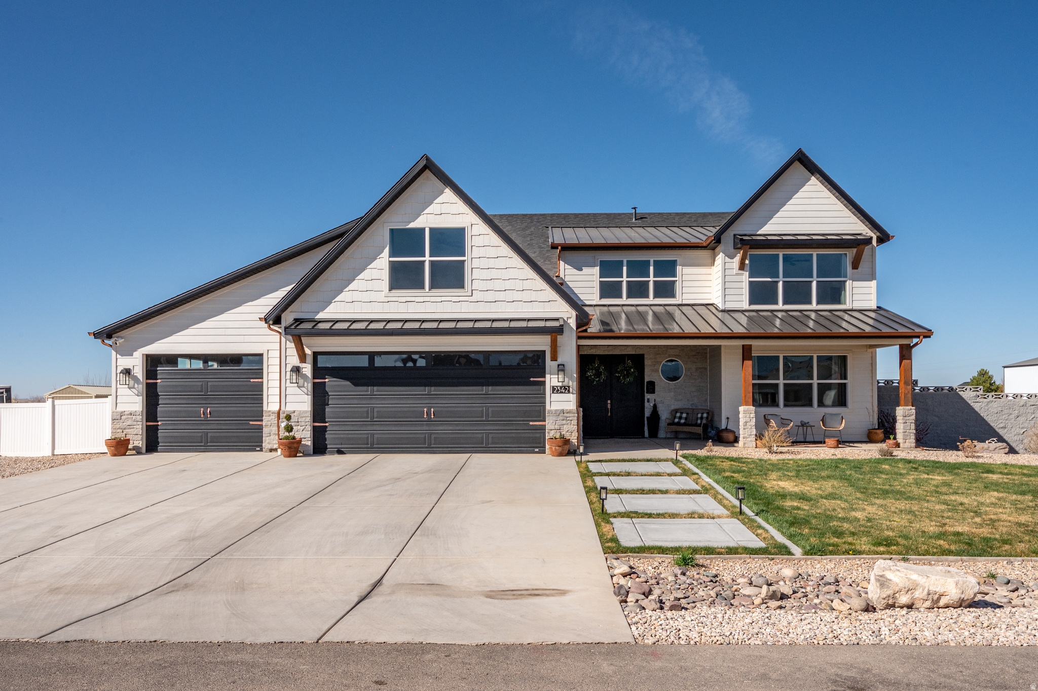 Spacious 2022 home offering 3,441 sq ft on nearly 1 acre with stunning mountain and city views. Thoughtfully designed with an open layout, high ceilings, and a well-appointed kitchen featuring granite countertops and multiple ovens. The main level includes a private office with built-ins and a functional mudroom with custom finishes. Upstairs bedrooms provide space and flexibility. Enjoy outdoor living with fruit trees, garden space with sprinklers, and an entertaining area with built-in BBQ and pizza oven. Fully fenced with a custom iron gate, additional concrete work, and a painted garage with epoxy floors. Located in a quiet area with room to live, work, and relax.