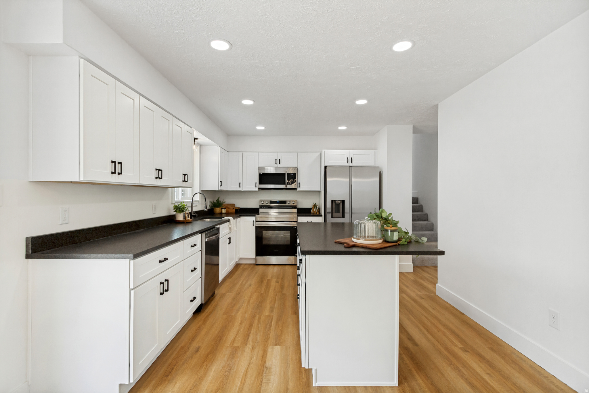 No showings until the open house this Saturday from 11am-1pm. Welcome to Utah County's hidden, affordable, ridge-top gem with views and upside you don't want to miss. Enjoy quiet cul-de-sac life on 1/3 acre! This 2,388 sq ft home has been fully remodeled from top to bottom. Major upgrades are already done-new roof, windows, HVAC, water heater, insulation, and vinyl fencing-all under the supervision of a licensed contractor. Inside, enjoy a stunning new kitchen with leathered granite, two beautifully updated bathrooms, and fresh finishes throughout. Multiple fun spaces round this one off. Turn one flex room into a theater room, game room, speakeasy, or library already complete with a dry bar and still have three more family/flex rooms that could be purposed for living spaces and/or spaces for guests or family to sleep. Pre-inspection report completed. New grass planted.