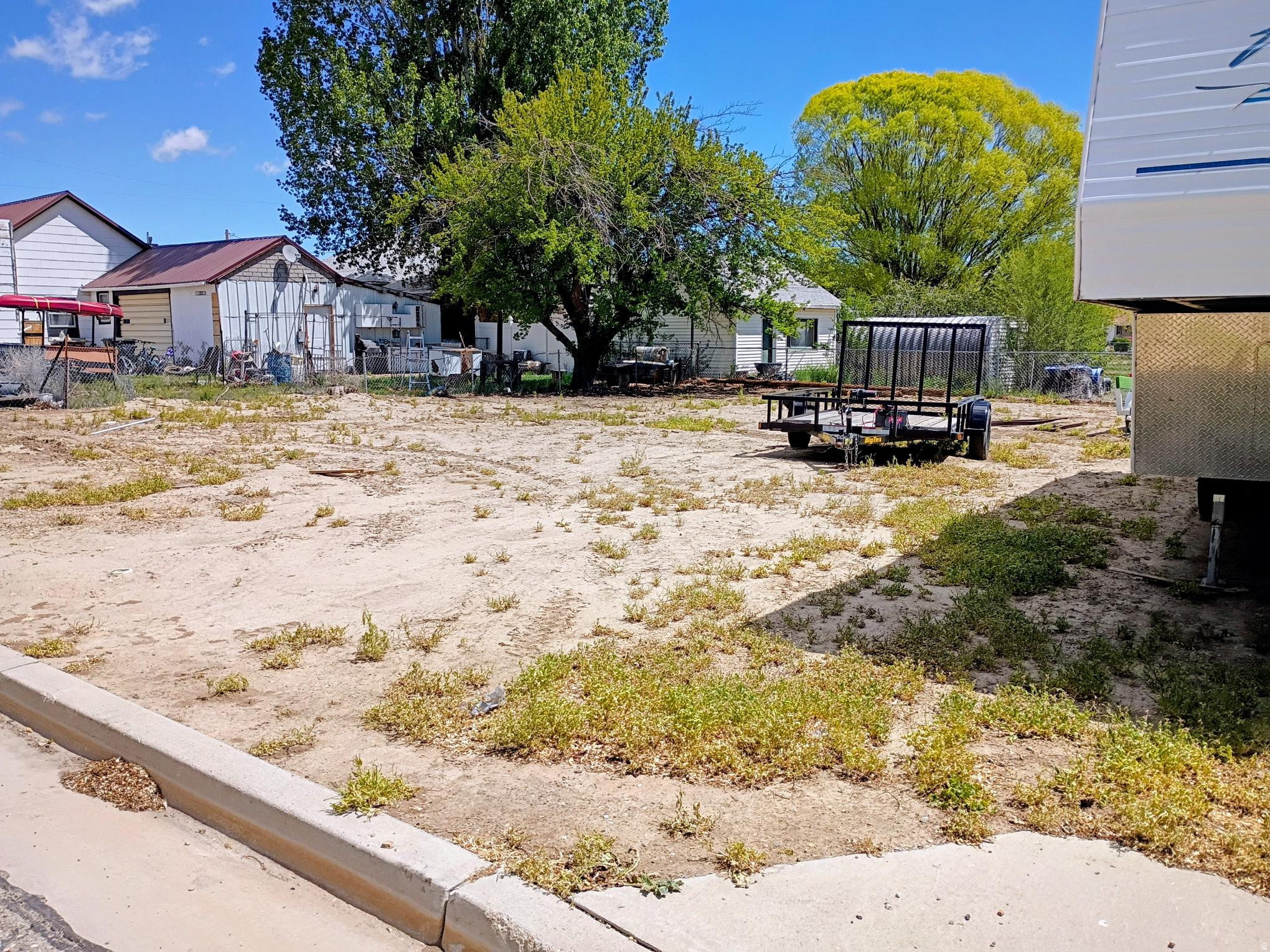 Nice level lot in Wellington City, now reduced by $10,000, offers excellent potential for a future home or investment. The culinary water, sewer, and secondary water connections are stubbed on the lot. The lot is partially fenced and was previously used as a garden area. Buyer should verify all costs, connection fees, lot size, and consult planning and zoning for building requirements. Single-wide mobile homes are not permitted per seller.