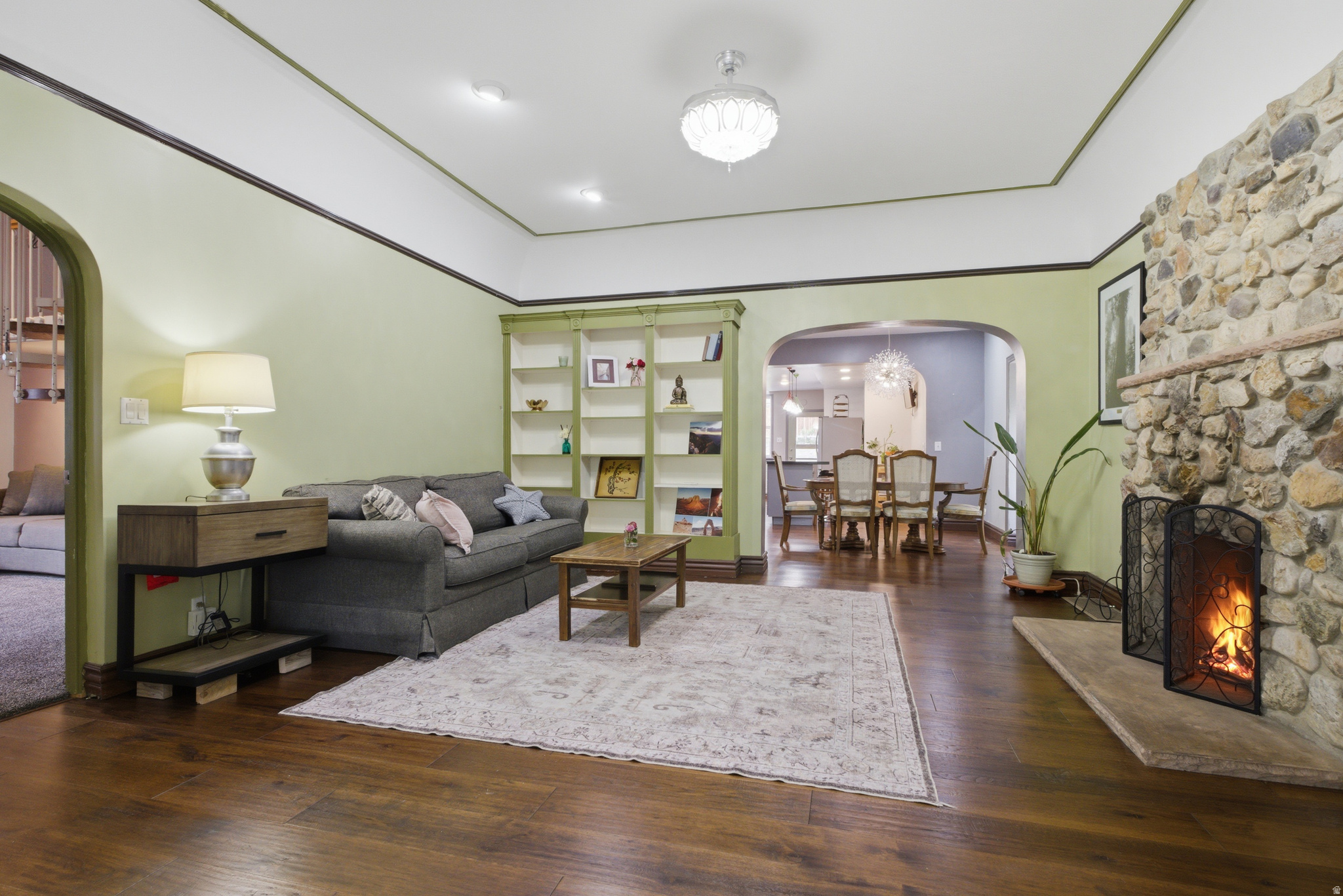 Built in 1891, this home has personality and character. From the locally sourced rock facade that carries inside with the stone gas fireplace, to the arched doorways and built in bookcases, there is a sense of charm that is unique to this house. The sunroom is a wonderful addition that brings in light and nature, along with the bay window in the dining room and the skylights in the kitchen. If you enjoy entertaining, this kitchen-dining- outdoor deck space is perfect for evening get-togethers and bbqs. The yard space is terraced and level, and the hot tub is included. Inside, there are three bedrooms with well designed layouts. Two of the three bedrooms capture loft space that creates multiple options for use. One of the bedrooms was once used as an ADU for students and short-term rentals allowing the property owner to earn extra income. The laundry-mud room is used for storage and has untapped potential. The unfinished basement houses the mechanicals. Water heater was updated in 2025 and the furnace was updated in 2020 & was recently serviced. There is even space for more storage or a possible man-cave or speak easy. Truly, this is one property you need to see in person.